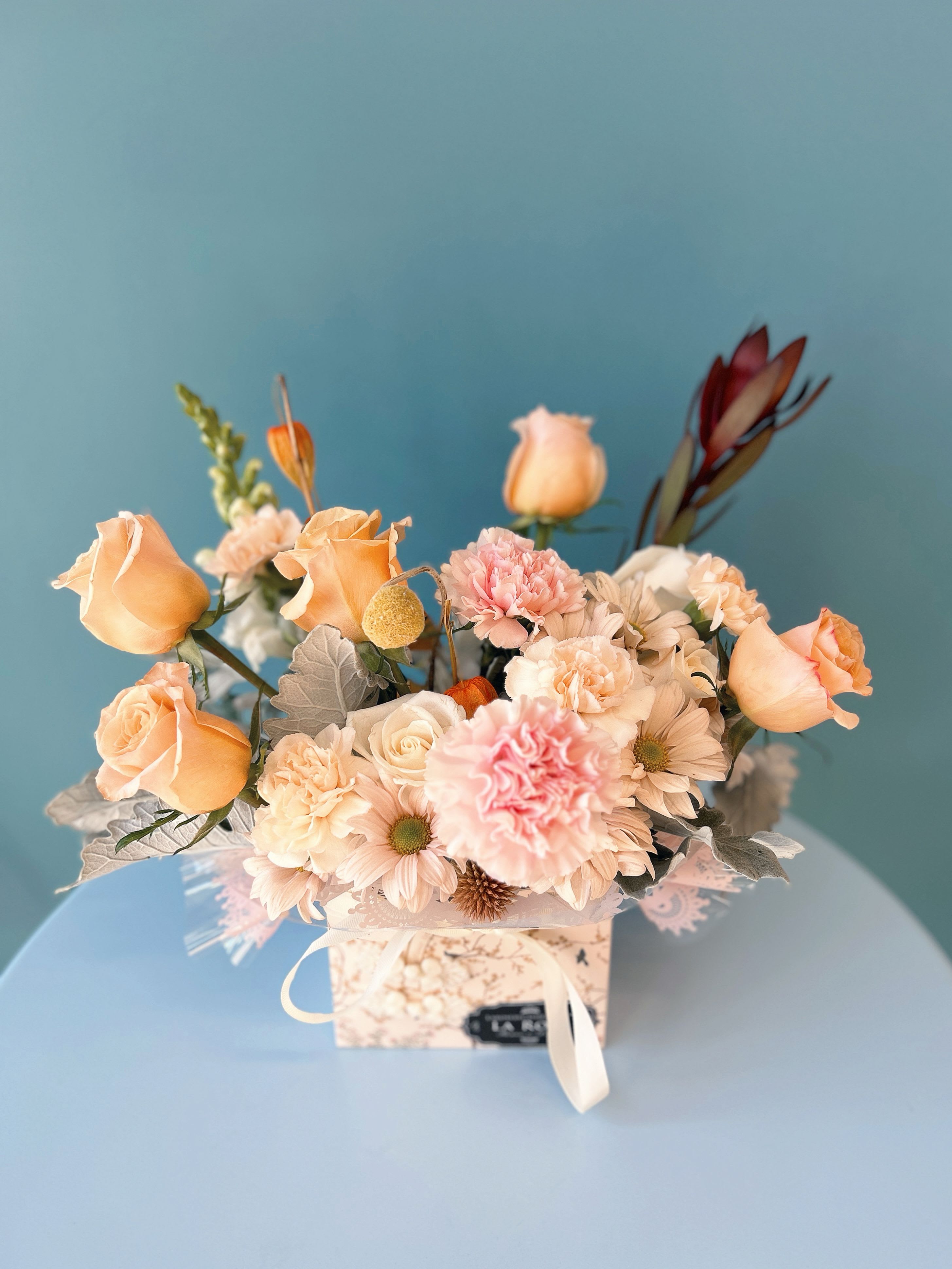 Fall Flower Box - Featuring premium local and imported variety of florals and foliage, beautifully arranged in a metal/ceramic/glass container with artistic luxury flower box.  standard size : 14-16 stems of florals deluxe size:  20-24 stems of florals premium size:  36-40 stems of florals  Leave us a note at the check out for your preferred colour theme and floral variety. It is NOT guaranteed that your final order will match what you requested but we will do our best to design accordingly.