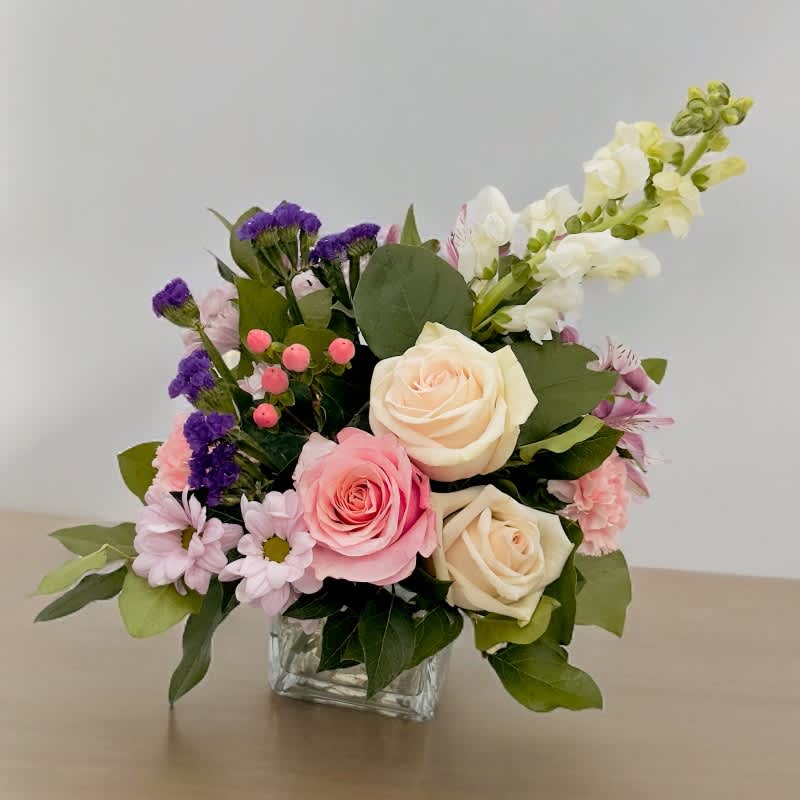 Aurora's Mysterious Radiance #12 - &quot;Aurora's Mysterious Radiance&quot; captures the ethereal and enigmatic light associated with Aurora, the Roman goddess of dawn. The roses symbolize admiration and enchantment, mirroring the rosy hues of dawn's first light. Mums evoke the tranquil, enigmatic atmosphere of twilight, while the alstroemeria represents the transition from night to day. White snapdragon brings purity and serenity and peach carnations add a touch of warmth and charm.  Let this bouquet remind you of the magical and mysterious radiance that graces the world with the arrival of a new day, filling your heart with hope and wonder.