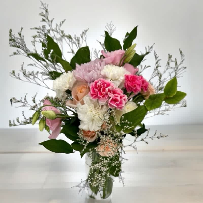 Áine’s Mighty Power #17 - &quot;Áine’s Mighty Power&quot; is a bouquet that exudes an aura of formidable strength. This arrangement draws from Áine, the Irish goddess linked to love and summer. It features white carnations, lavender mums, peach roses, white roses, lisianthus, and mini carnations. This bouquet embodies a multifaceted strength that can empower and inspire. Let it remind you of the mighty power within and around you, embracing love, abundance, and sovereignty with grace and fortitude.