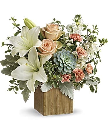Peach Garden Delight Peach Garden Delight - Peach Garden Delight beautiful designed in a wood box with lilies, spray roses, roses, Succulents, with mixed. We may have to substitute succulent. We will definitely add some extra flowers if that is the case.