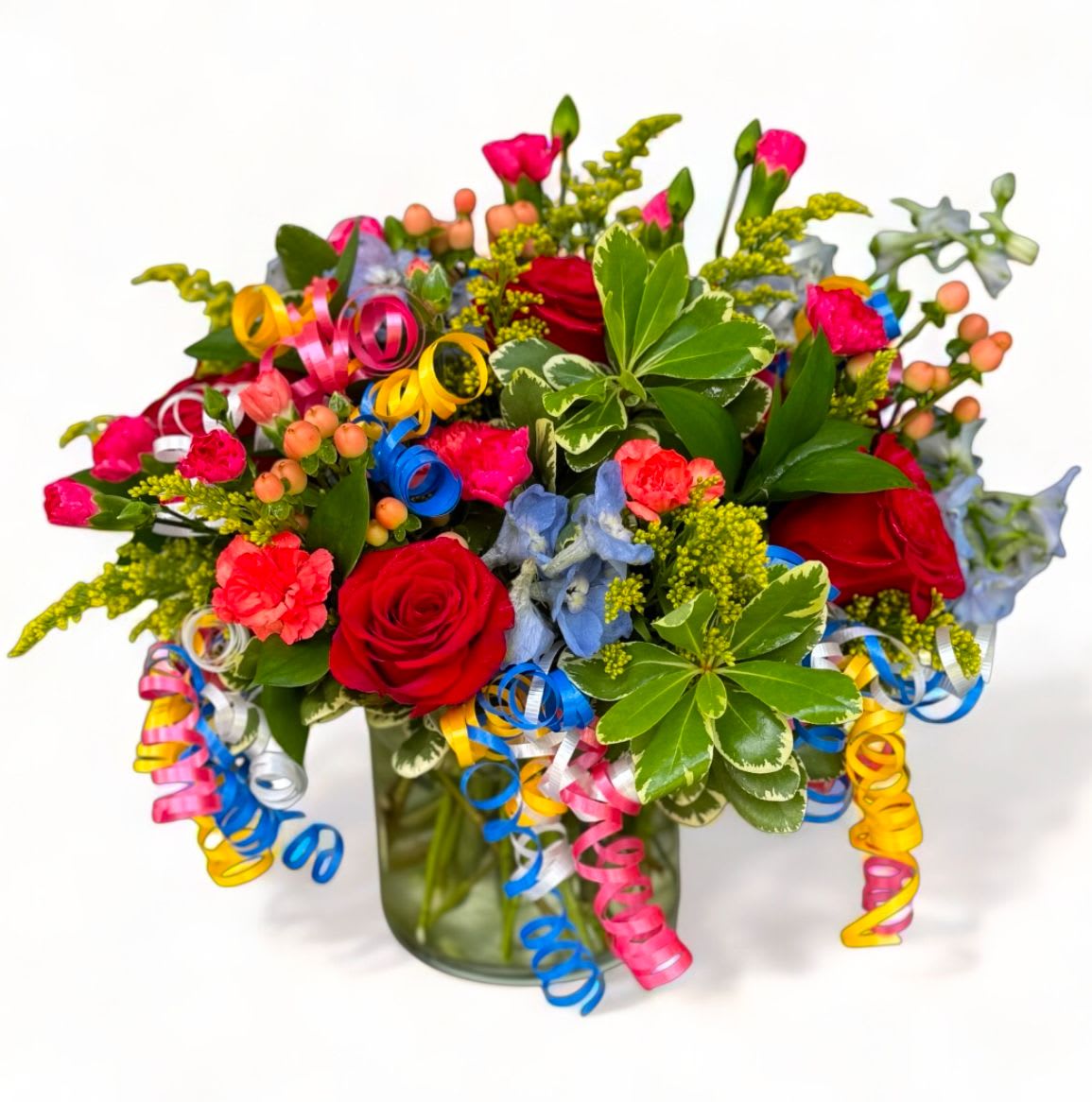 Birthday Bash! Birthday Bash! - Assorted variety of fresh flowers including roses, hypericum berries, delphinium, solidago and mini carnations arranged in a vase. Accented with colored curly streamers and premium greeneries.