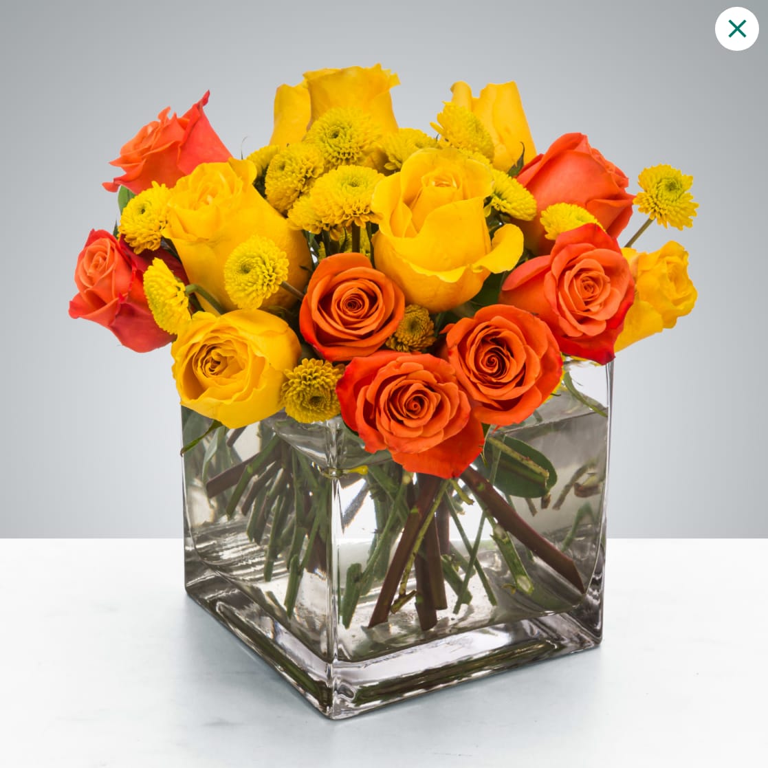 Cheer Up Buttercup  - Yellow and orange roses come together for a fun and fresh arrangement. A great arrangement to send to both men and women as a gift, these flowers light up any room. Send this for admin professionals week, Cinco De Mayo, or a birthday.  Approximate Dimensions: 10&quot;D x 10&quot;H