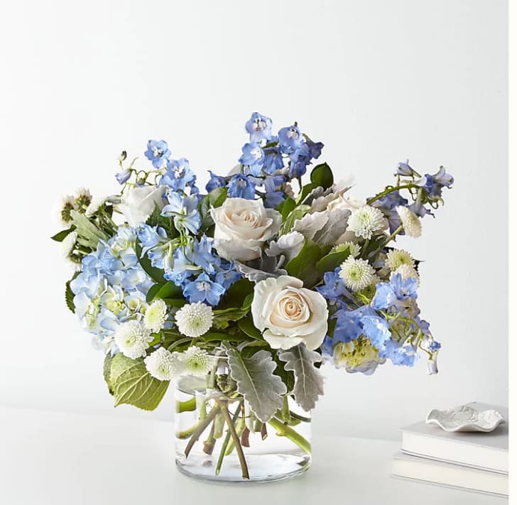 Clear Skies Bouquet - FTD design, let this uplifting arrangement be reminders of the clear skies ahead. Capturing the feeling of hope that a new day brings, this bouquet is composed of voluminous hydrangea blooms and vibrant belladonna delphinium to refresh their mood