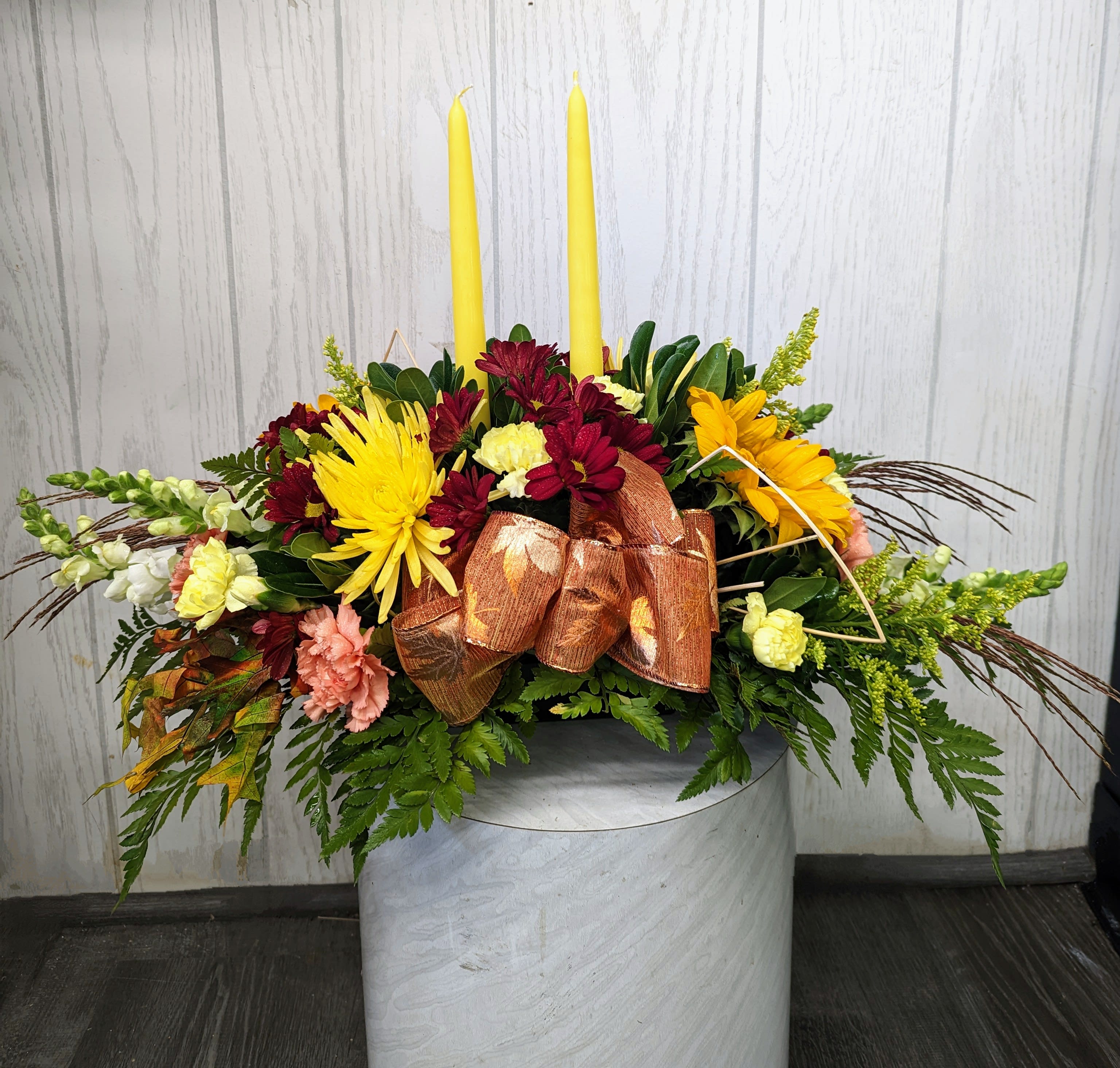 Two Candle Fall Centerpiece Two Candle Fall Centerpiece - A Thanksgiving feast is not complete without a centerpiece! ***FLOWER SUBSTITUTIONS/DESIGNER’S CHOICE*** is required due to limited product offerings. The flowers may be substituted, but the beauty, and price value will be maintained. Thank you for your understanding!