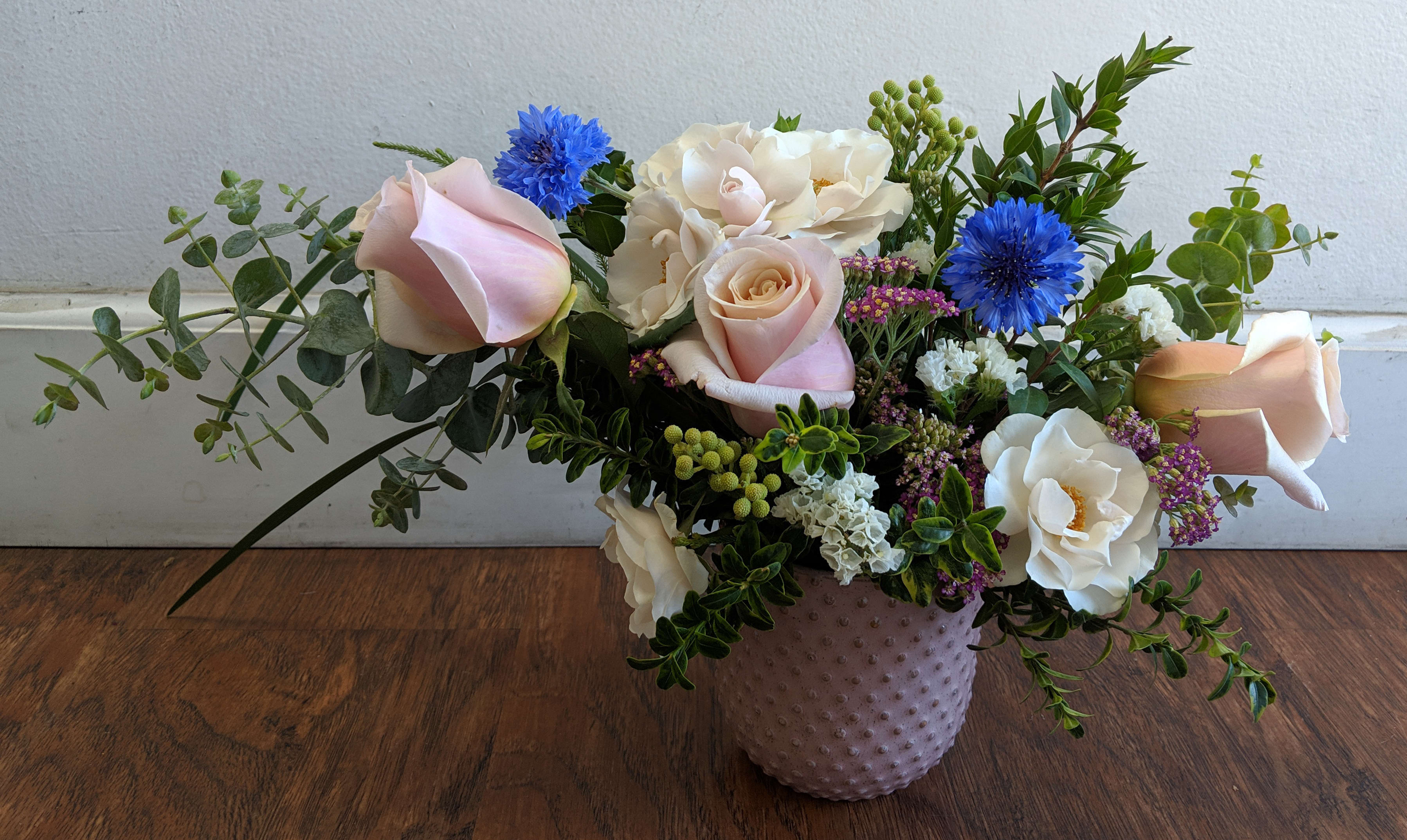 Two Blue Butterflies - An organic, flowy arrangement with pops of blue corn flower that reminds one of butterflies fluttering into a garden. 