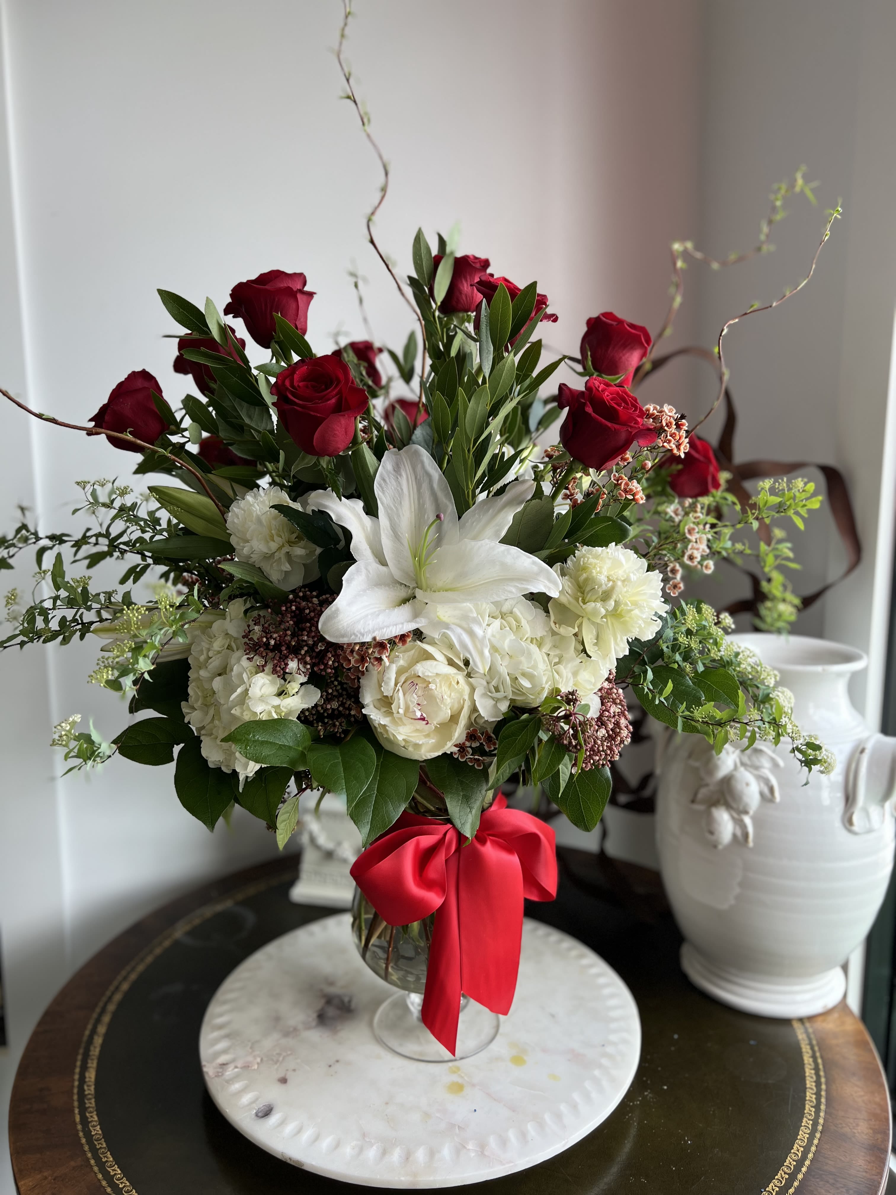 One Dozen Red Roses - A dozen premium 70 cm Ecuadorian roses, Arranged in a hourglass shaped vase hydrangea, oriental lilies and peonies.