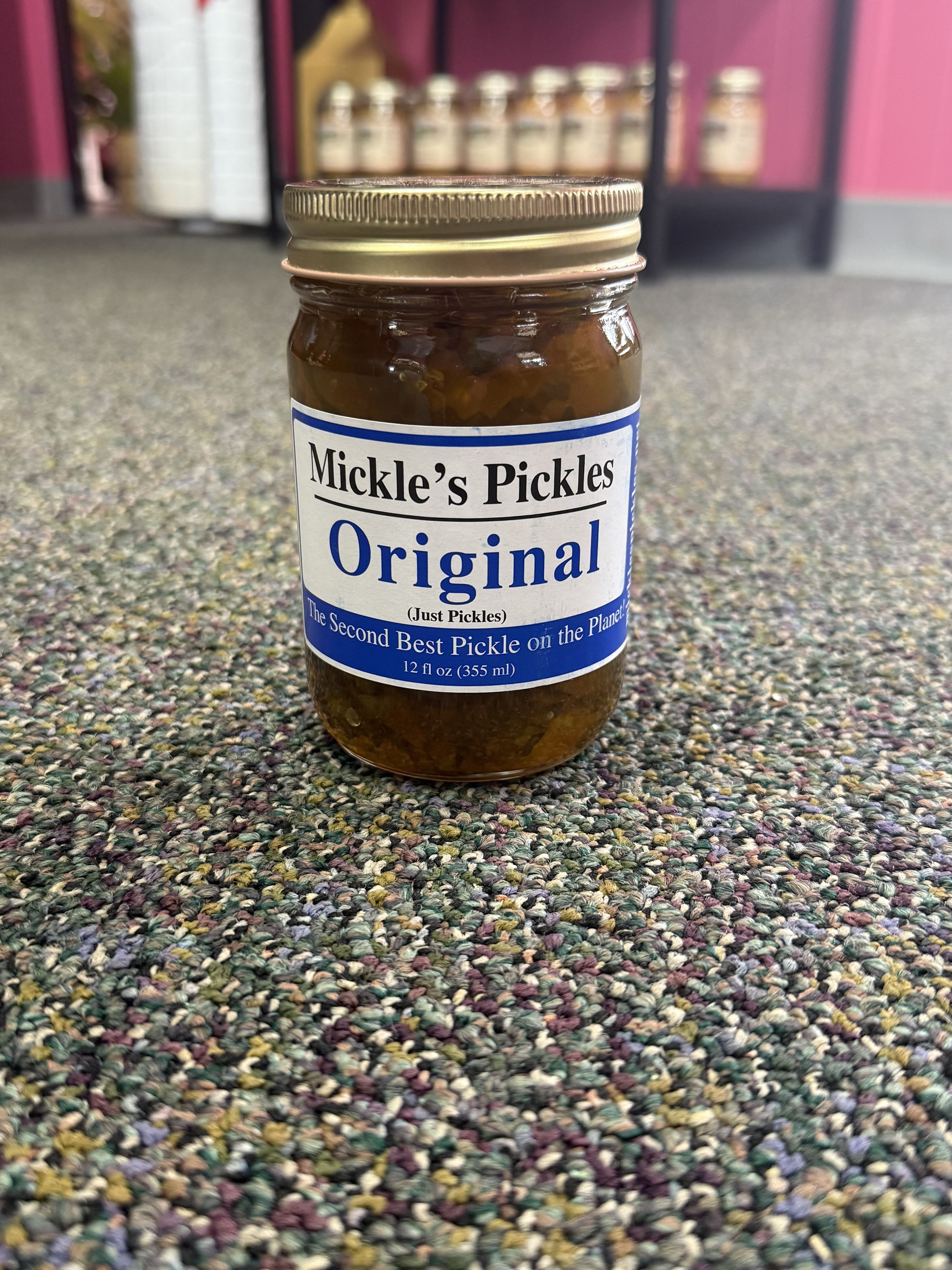 Mickle's Pickles Original Pickles - Introducing Mickle's Pickles Original Pickles. These 12oz jars are packed with cucumbers pickled to perfection using a blend of water, vinegar, salt, and an array of natural flavors. Infused with a hint of sugar and hot sauce, they offer a unique taste that's low in sodium and free of antibiotics. The garlic added to our pickles gives them a distinct flavor that's hard to resist. And the best part? They're shelf-stable with a life of 24-36 months and come in plastic-free packaging. Whether you're a food connoisseur or just a pickle lover, our pickles are sure to satisfy your palate. Details • Made in United States • Diet: Alcohol-free, Dairy-free, Gluten-free, Low fat, Low sodium, Soy-free, and Vegetarian • Production: Locally sourced, No added hormones, and No antibiotics • Shelf life: 24-36 months • Storage: Shelf-stable • Ingredients: Pickles(Cucumbers, Water, Vinegar, Salt, Calcium Chloride [firming agent, Sodium, Benzoate [preser... • Product Language: English • Weight: 1lb (453.59 g) • Dimensions: 16 x 16 x 12 in (40.6 x 40.6 x 30.5 cm)