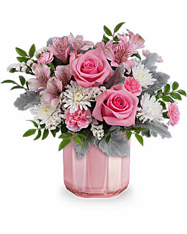 Teleflora's Sweet Blooms Bouquet - Delicate and charming, this pastel pink Valentine's Day bouquet is beautifully complemented by a sculpted pink glass vase featuring a shimmering pearlescent finish. This charming Valentine's Day bouquet features pink roses, pink alstroemeria, miniature pink carnations, and white cushion spray chrysanthemums, arranged with dusty miller and huckleberry. It's delivered in the Blushing Gem vase.
