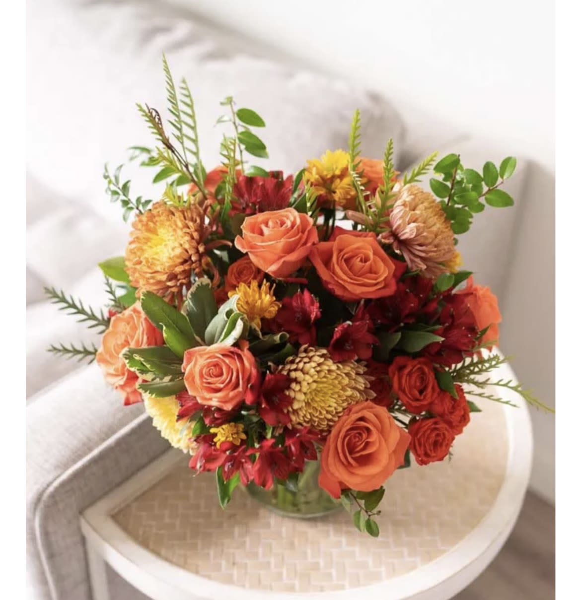 Autumn Sunset  - Warm Fall colored flowers in a glass cylinder or cube roses , alstromeria , mums , fall foliage 