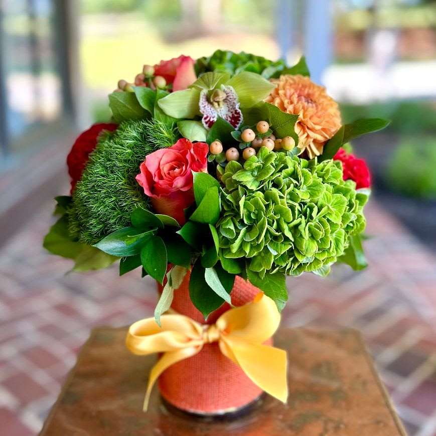 Cayenne Spice Cayenne Spice - This orange burlap wrapped vase is filled with premium orange roses, green hydrangea, green trick, hypericum, kale, protea and celosia. Same day, tax free hand delivery. We are a local florist in Wilmington, Delaware that delivers fresh flowers on the same day for delivery near you. Our flower shop services the Wilmington and Newark Delaware areas. We are a flower shop near you that is tax free and provides hand delivered flowers. We offer sympathy flowers and are a full service florist that offers online flowers and fresh flower arrangements. You can send flowers from our flower shop to Wilmington, New Castle, Newark, Hockessin, Chadds Ford, Kennett Square and other local cities near us.