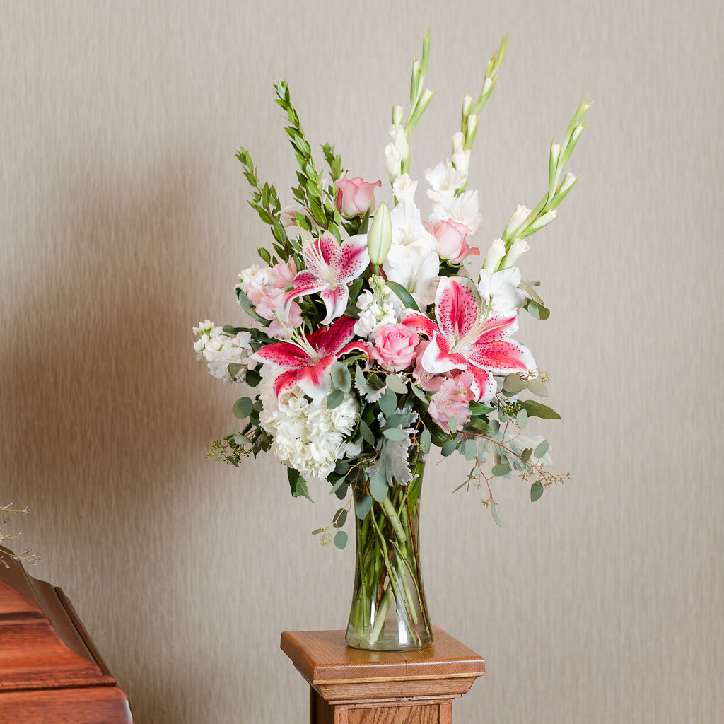 Charity - A vase arrangement in soft pinks and whites that create a vivid statement to express your sympathies.