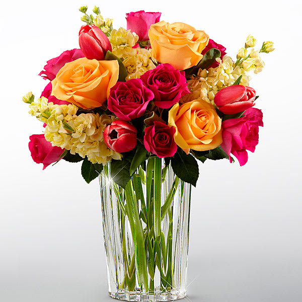 The FTD Beauty and Grace Bouquet by Vera Wang The FTD Beauty and Grace Bouquet by Vera Wang - FTD® proudly presents the Vera Wang Beauty and Grace™ Bouquet. A stunning display of sun-crushed sophistication this bouquet of fuchsia tulips pale yellow stock peach roses and hot pink spray roses demands their attention. Presented in a modern clear glass vase this incredible arrangement is sure to convey your warmest wishes with each sunlit bloom.