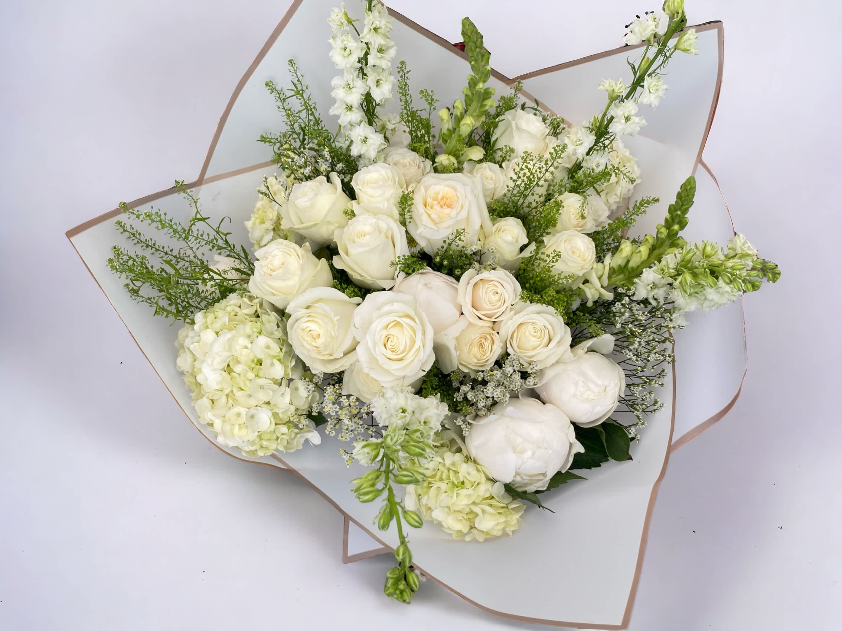 White roses bouquet White roses bouquet - A mixture of white roses and other seasonal flowers. We offer different colors and styles for wrapping paper. Please note in Florist Instructions your choice of wrapping paper. We have one solid color like red, pink, white, classic brown, clear, etc. We also have two side colors like white/gold, light pink/hot pink, pink/purple, blue/white etc. And lastly, we have them in shiny/iridescent colors, or texture/style paper. Call us at 323-961-6686 if you have any questions.
