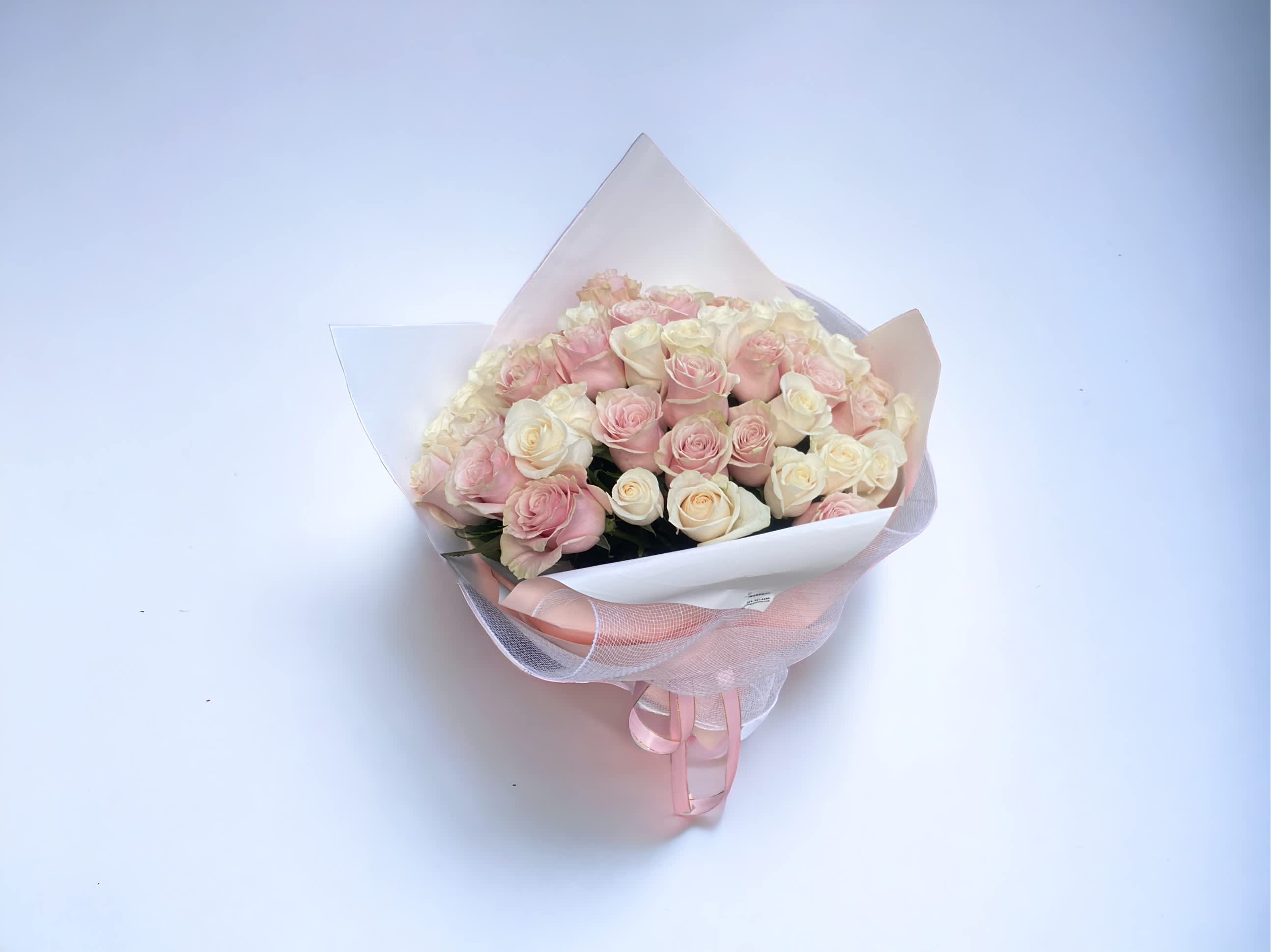 Just pink and white roses - A dozen of long stem pink roses and a dozen of long stem white roses only with your choice of wrapping paper. Deluxe is for 30 roses. Premium is 36 roses.  We offer different colors and styles for wrapping paper. Please note in Florist Instructions your choice of wrapping paper. We have one solid color like red, pink, white, classic brown, clear, etc. We also have two side colors like white/gold, light pink/hot pink, pink/purple, blue/white etc. And lastly, we have them in shiny/iridescent colors, or texture/style paper. Call us at 323-961-6686 if you have any questions.