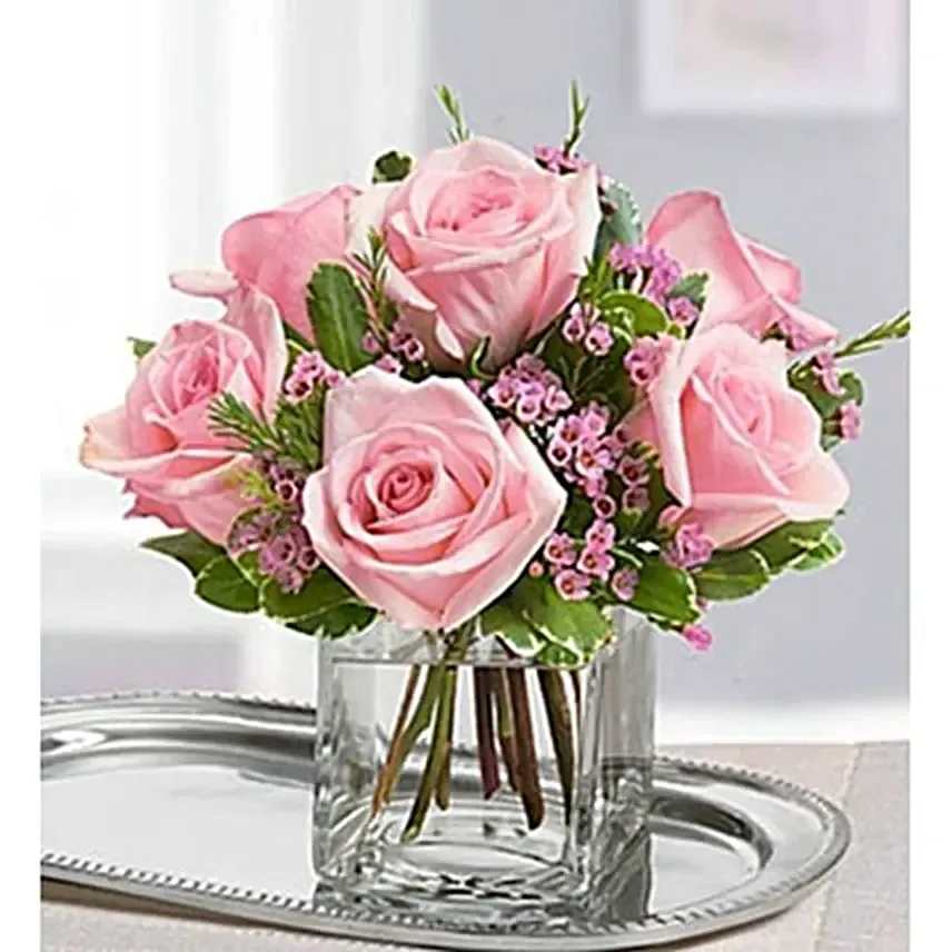 Pristine  - Light pink shade 12 roses with small wax flower in a square clear vase.