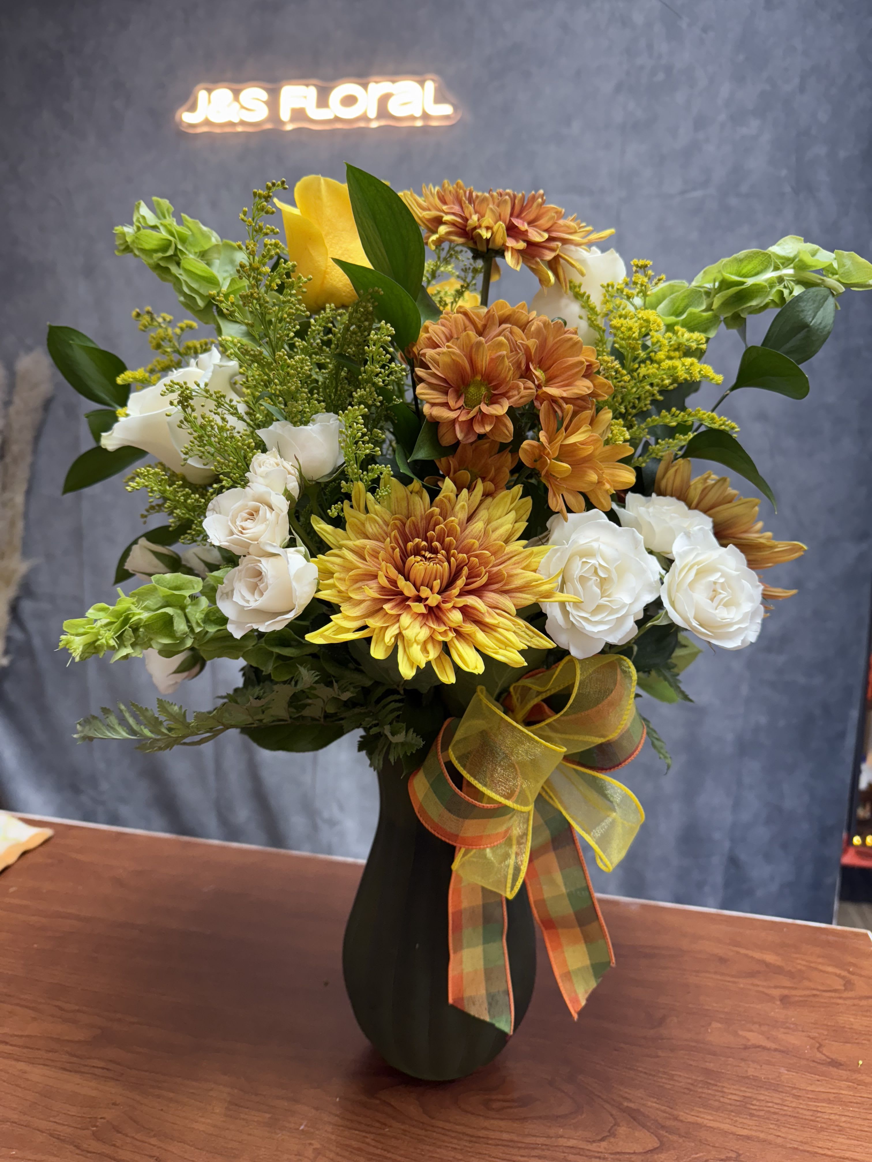 Fall Hues Fall Hues - Embrace the beauty of fall with our exquisite fall arrangement! Handcrafted with vibrant hues of fall colors, our arrangements capture the essence of the season. Perfect centerpiece to brighten someone's day :)