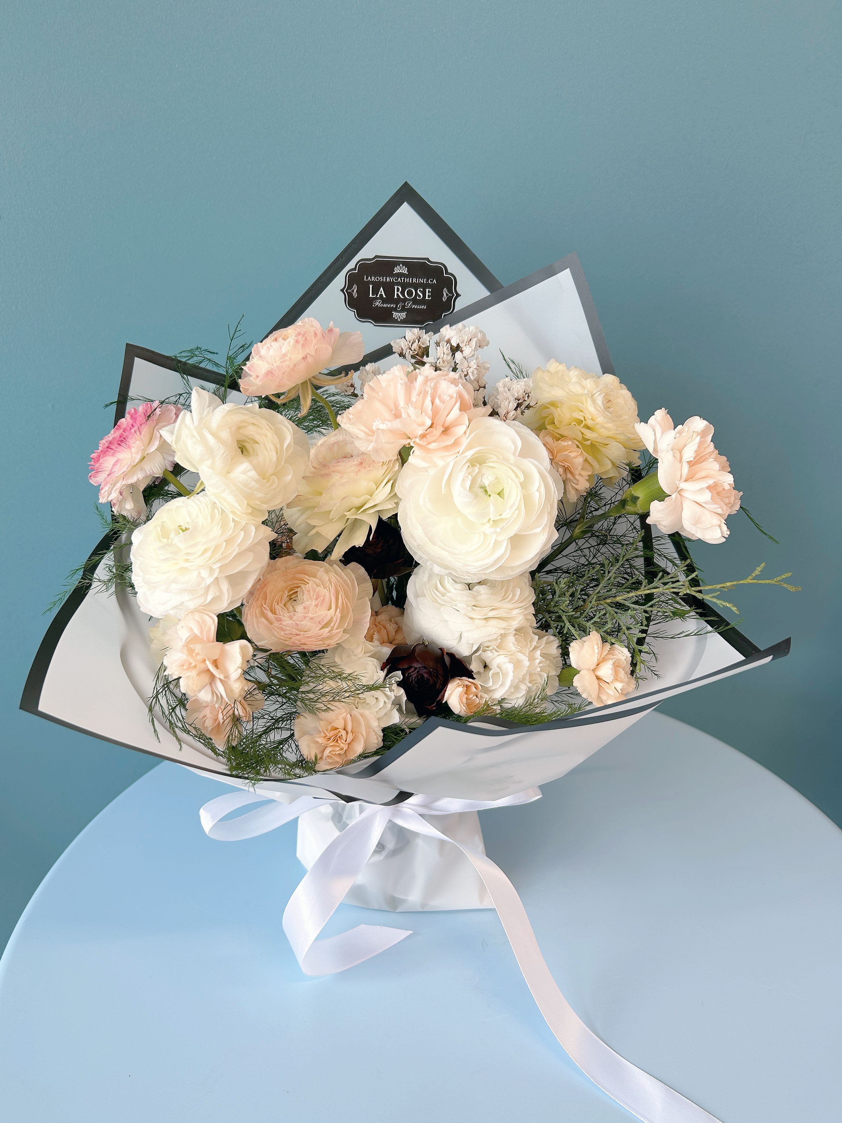 &quot;LOVE IS PURE&quot; Pastel Vase Bouquet - Elevate any occasion with our premium seasonal fresh blooms, artfully arranged with lush foliage and designed to your preferred color palette.   Each bouquet is wrapped in luxurious designer paper and packaging, adding a sophisticated touch. Whether for weddings, special events, or everyday moments, these stunning arrangements are crafted to impress.   Choose your favorite colors and let us deliver fresh, beautifully packaged blooms straight to HER door.   standard size:  14-16 florals deluxe size:  20-22 florals premium size:  26-28 florals  Leave us a note at the check out for your preferred colour theme and floral variety. It is NOT guaranteed that your final order will match what you requested but we will do our best to design accordingly.