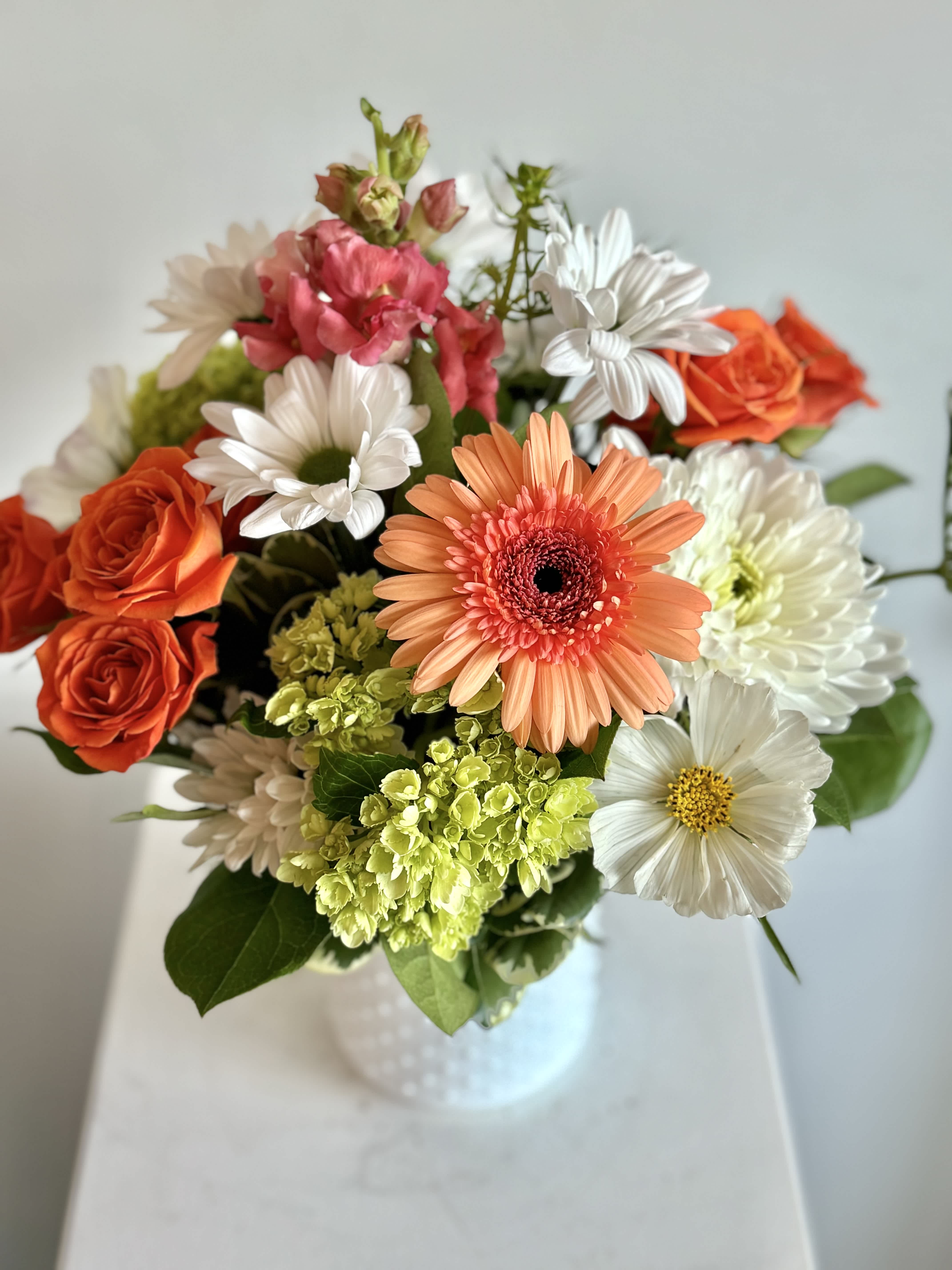 Creamsicle  - Our signature white milk glass vase is bursting with oranges, whites, peaches and green.  This is perfect for a birthday or any occasion.  PLEASE READ SUBSTITUTION POLICY