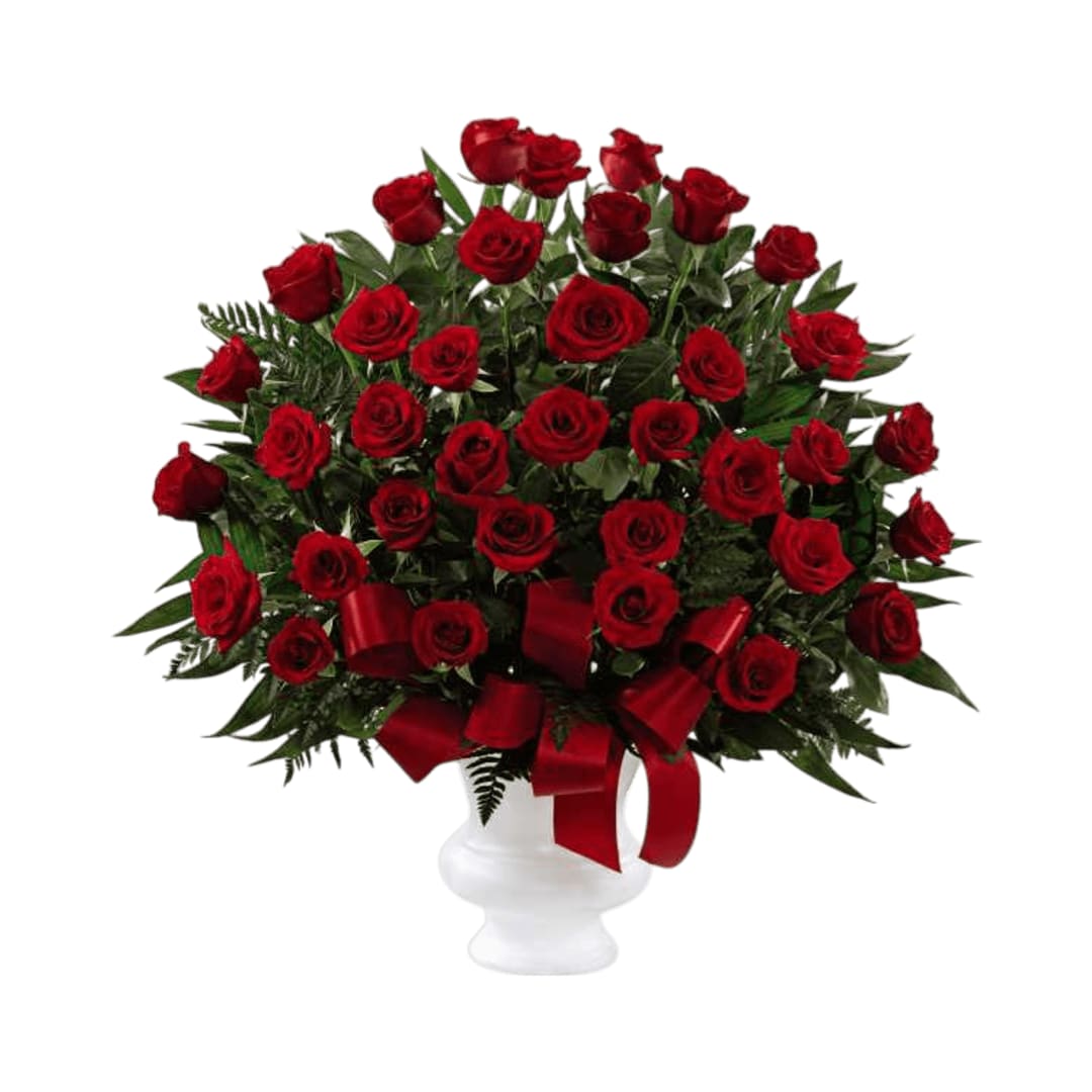 Soul's Splendor Arrangement Soul's Splendor Arrangement - Soul's Splendor Arrangement is a rich display of the love shared throughout the life of the deceased. Brilliant red roses are elegantly displayed in a white designer plastic urn and accented with lush greens and red satin ribbon to create a beautiful tribute to honor your special relationship.