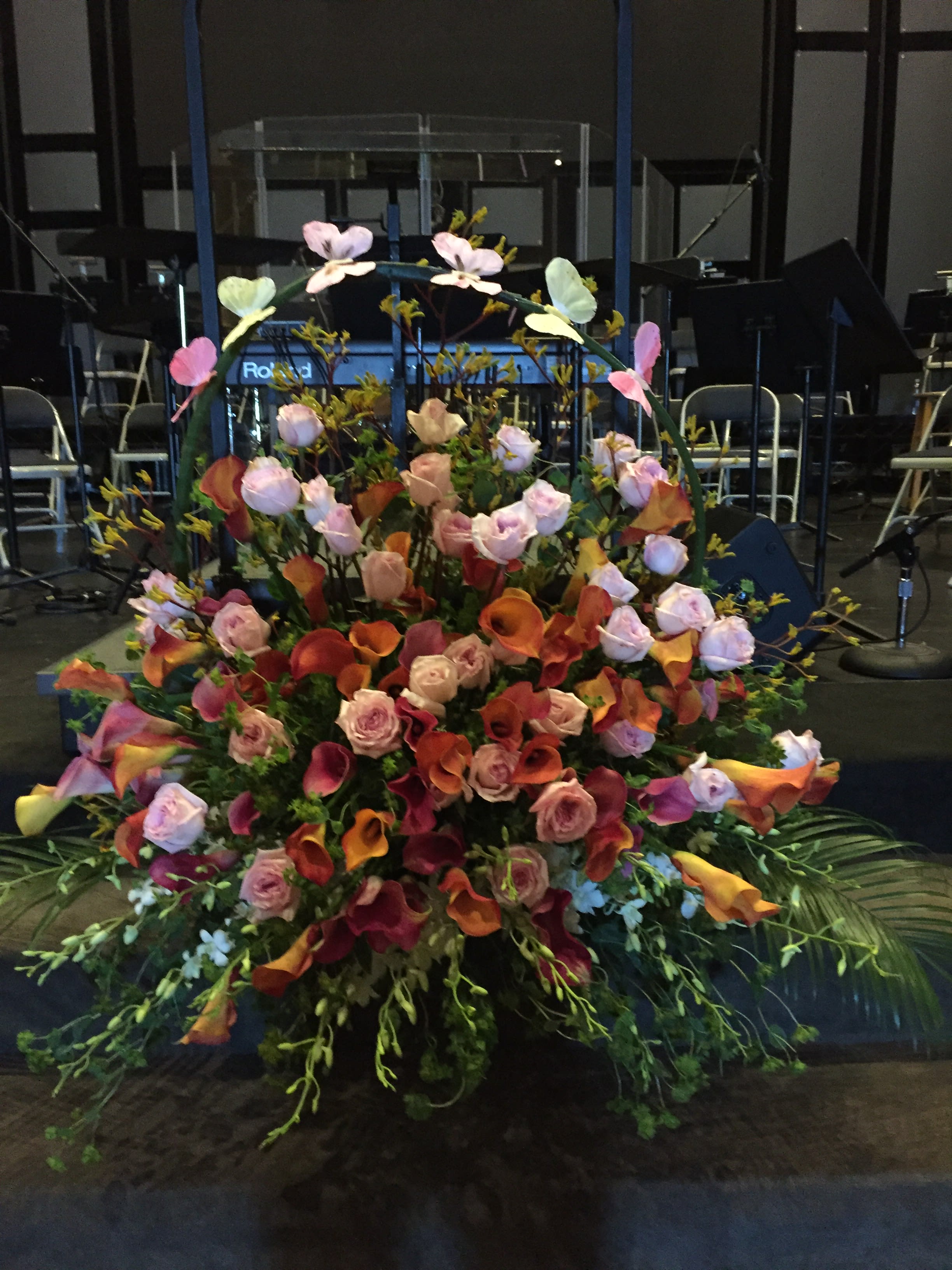 BUTTERFLIES ARE FREE BUTTERFLIES ARE FREE - A LARGE ARRANGEMENT OF CALLA LILIES,ROSES AND ORCHIDS WITH AN ARCH OF SANSEVIERIA CYLINDRICA