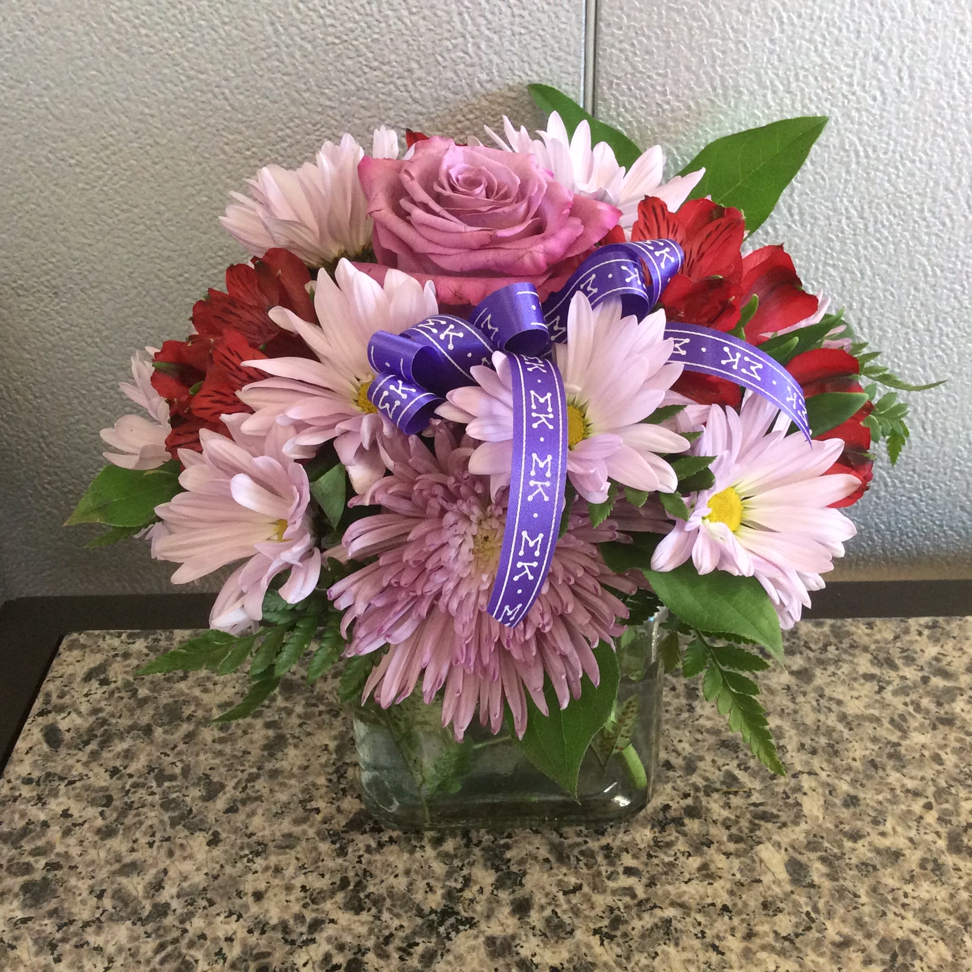 Sigma Kappa Cube Sigma Kappa Cube - Roses, alstromeria daisies & fuji mums arranged in glass cube - Approx. Height 13"