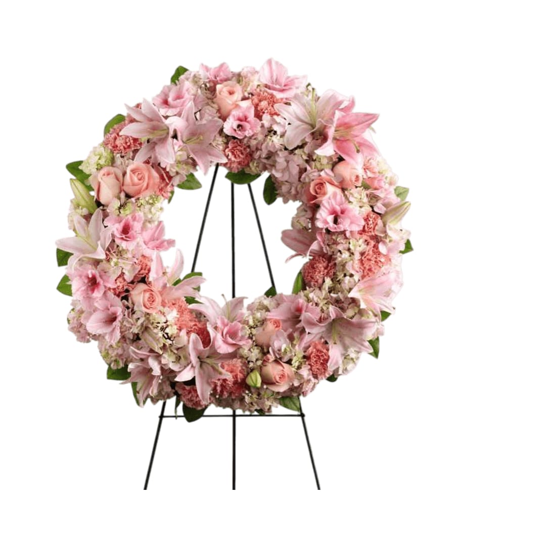 Loving Remembrance Wreath Loving Remembrance Wreath - Loving Remembrance Wreath is a blushing display of grace and beauty to honor the life of the deceased at their final tribute. Pink roses, Oriental lilies, gladiolus, hydrangea and carnations are brought together with lush greens to form the shape of a wreath, offering warmth and comfort with its sweetly sophisticated elegance. Displayed on a wire easel.