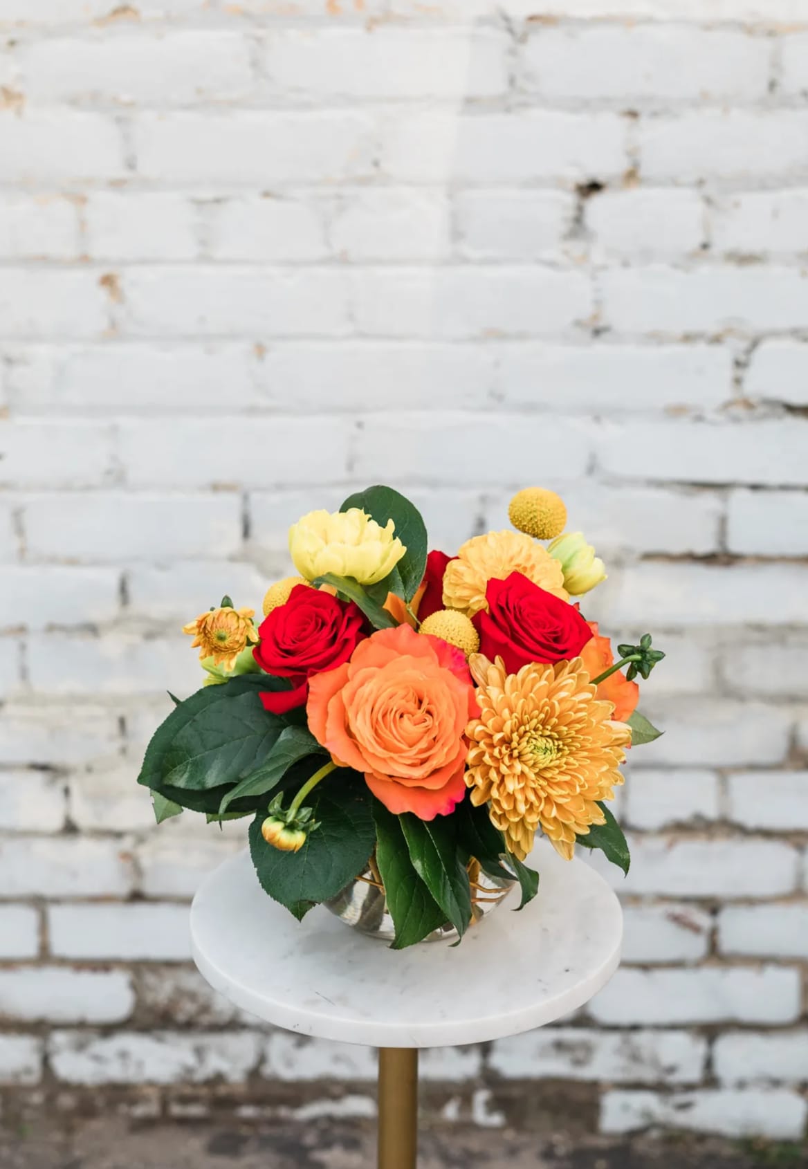 Fiery Sky - Celebrate the clear skies and summer vibes with our new Summer Collection! Inspired by the natural masterpiece of the sky, the Fiery Sky comes arranged with a dazzling mix of yellow, orange, and red premium blooms and textures, all eloquently designed in one of our hand-picked designer glass vases.  Pictured [DELUXE]  *Some items in this arrangement must be special ordered, please allow 1-2 weeks notice to allow time for arrival of special items, otherwise, substitutions will occur.*