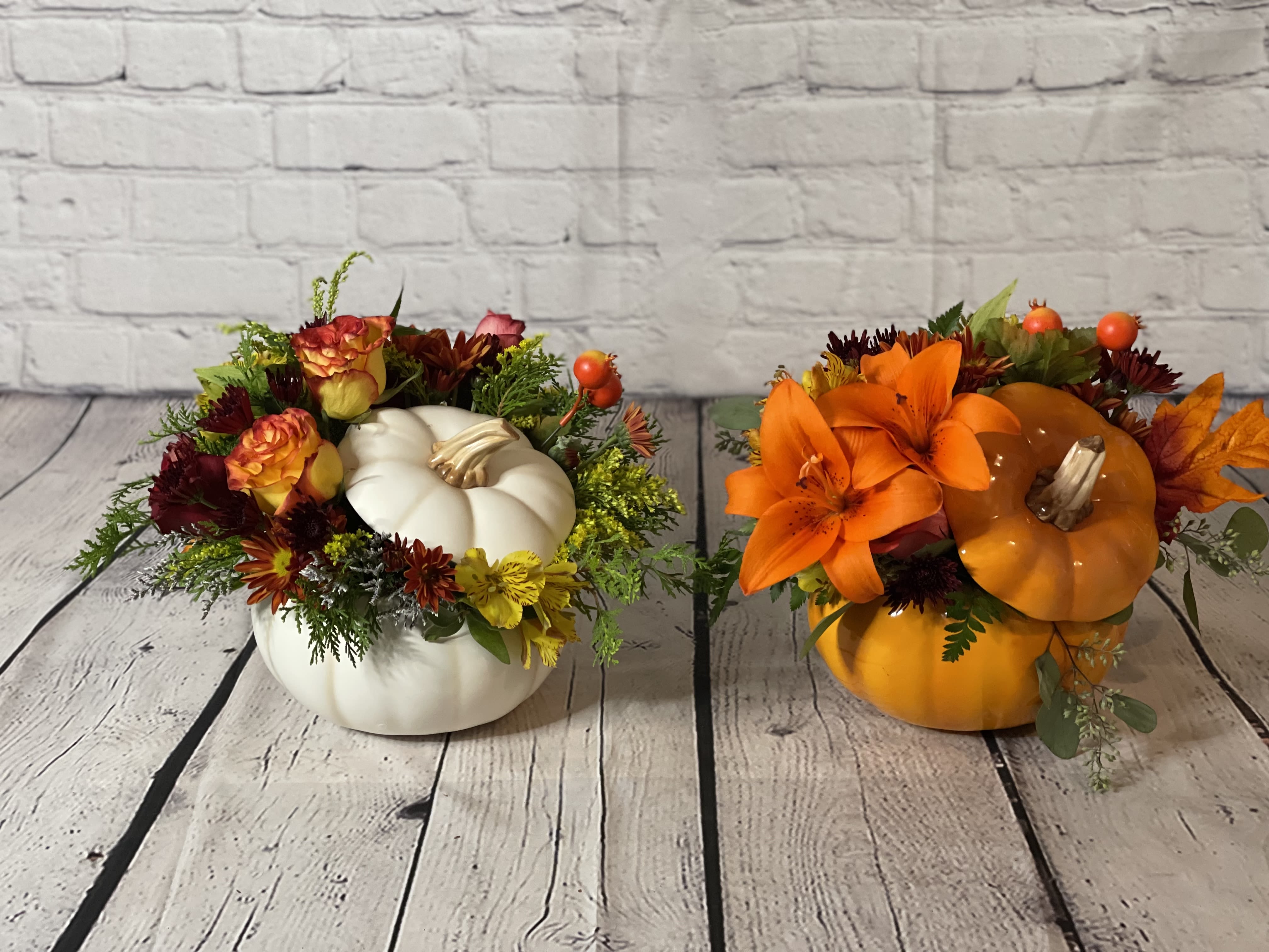The Harvest Glory (Pumpkin colors) - The Harvest Glory floral arrangement captures the essence of the autumn season beautifully, arranged in a ceramic pumpkin in striking autumn tones of white, orange, or sage. This stunning tribute showcases the rich and vibrant colors of fall foliage and blooms, creating a warm and inviting centerpiece that embodies the spirit of the season. Perfect for adding a touch of seasonal charm to any space, the Harvest Glory arrangement is a delightful celebration of autumn's beauty in all its glory.  PLEASE SELECT THE COLOR OF YOUR CERAMIC PUMPKIN IN THE &quot;NOTES FOR THE FLORIST&quot; SECTION DURING CHECKOUT.   