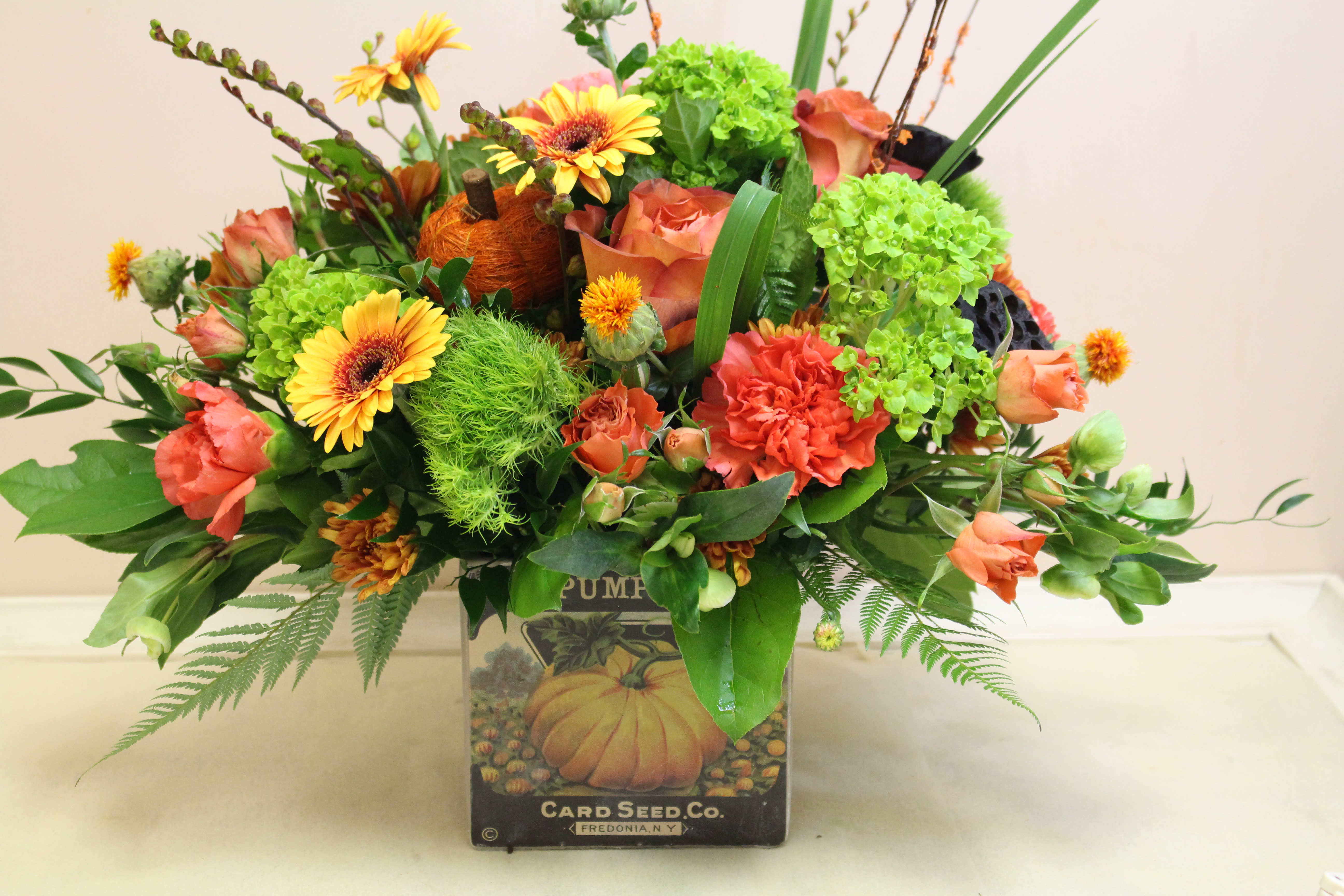 antique pumpkin patch - a distressed pumpkin scene set on a cement cube filled with a autumn arrangement