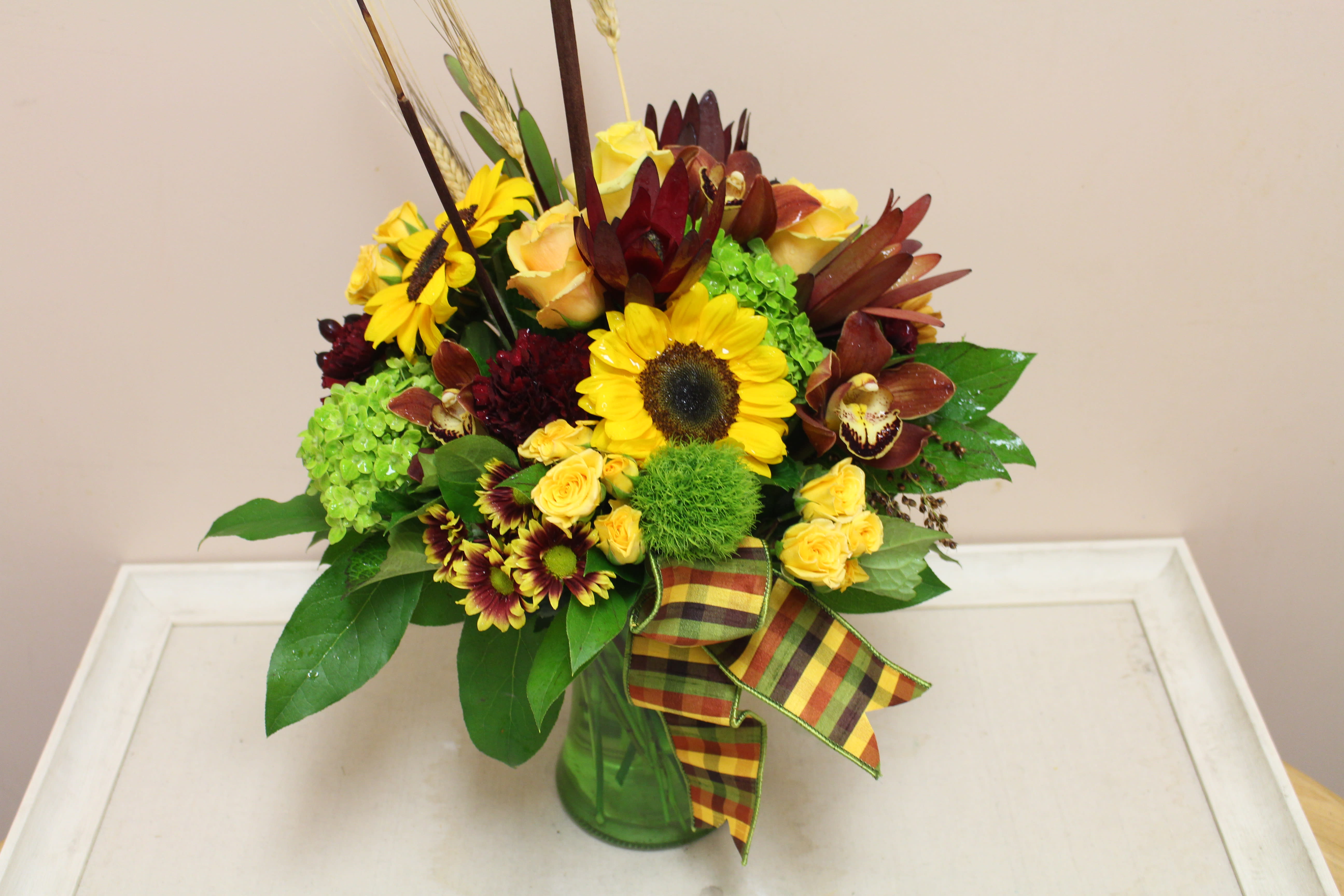 Autumn Dance - Autumn vase filled with mixed autumn flowers, assorted poms, spray roses, mini green hydrangea, carnations and more.  Comes in assorted colors