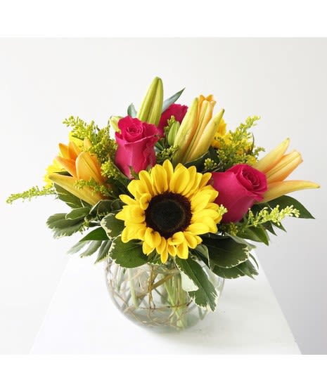 Hugs and kisses Hugs and kisses - Pink roses, vibrant orange lilies and sunflowers delivered in a lush cube or bubble bowl