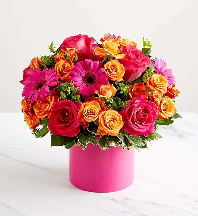 Electric Love Electric Love - Rich hot pink roses, sweet as can be orange babe spray roses and the perfect shade of pink gerberas round out this lush arrangement.