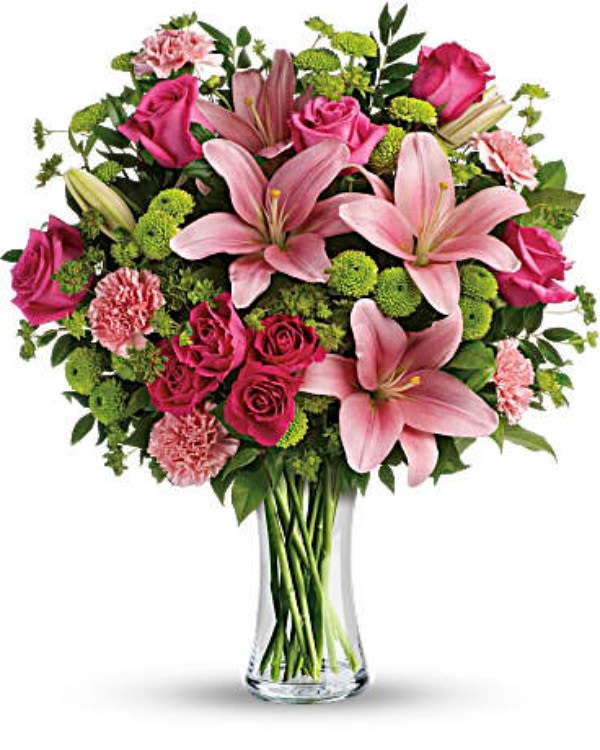 The Stella Monroe The Stella Monroe - What’s better than pink? More pink! Show someone you care with this blissful bouquet of roses and lilies, hand-delivered in a classic glass vase. It’s an impressive gift that promises to put some pink in her cheeks! This fabulously feminine bouquet features hot pink roses, hot pink spray roses, pink asiatic lilies, pink carnations, green button spray chrysanthemums and fresh greens. Delivered in a clear glass vase.