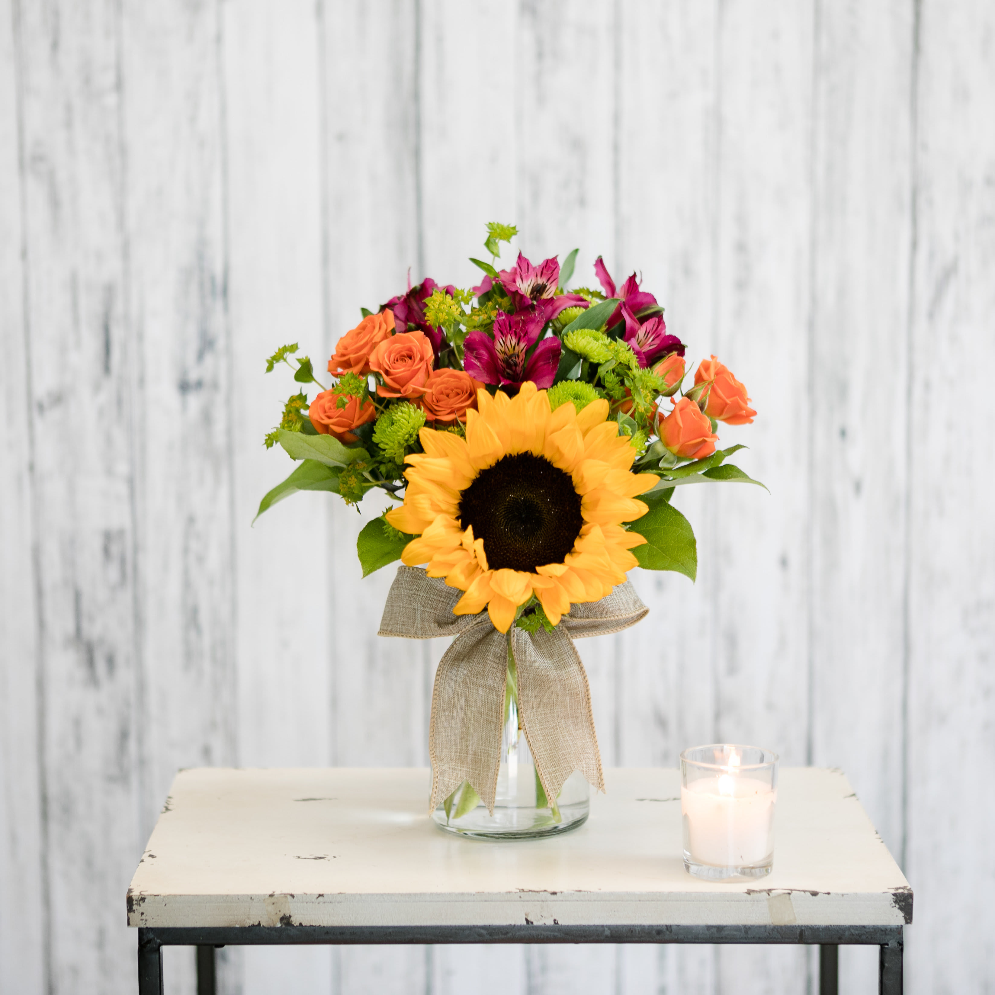 Brilliant - Vibrant and bold~ a vase filled with orange, purple and green blooms with a sunflower front and center is sure to bring a smile!  Approximate Dimensions: 19&quot; H X 9&quot; W