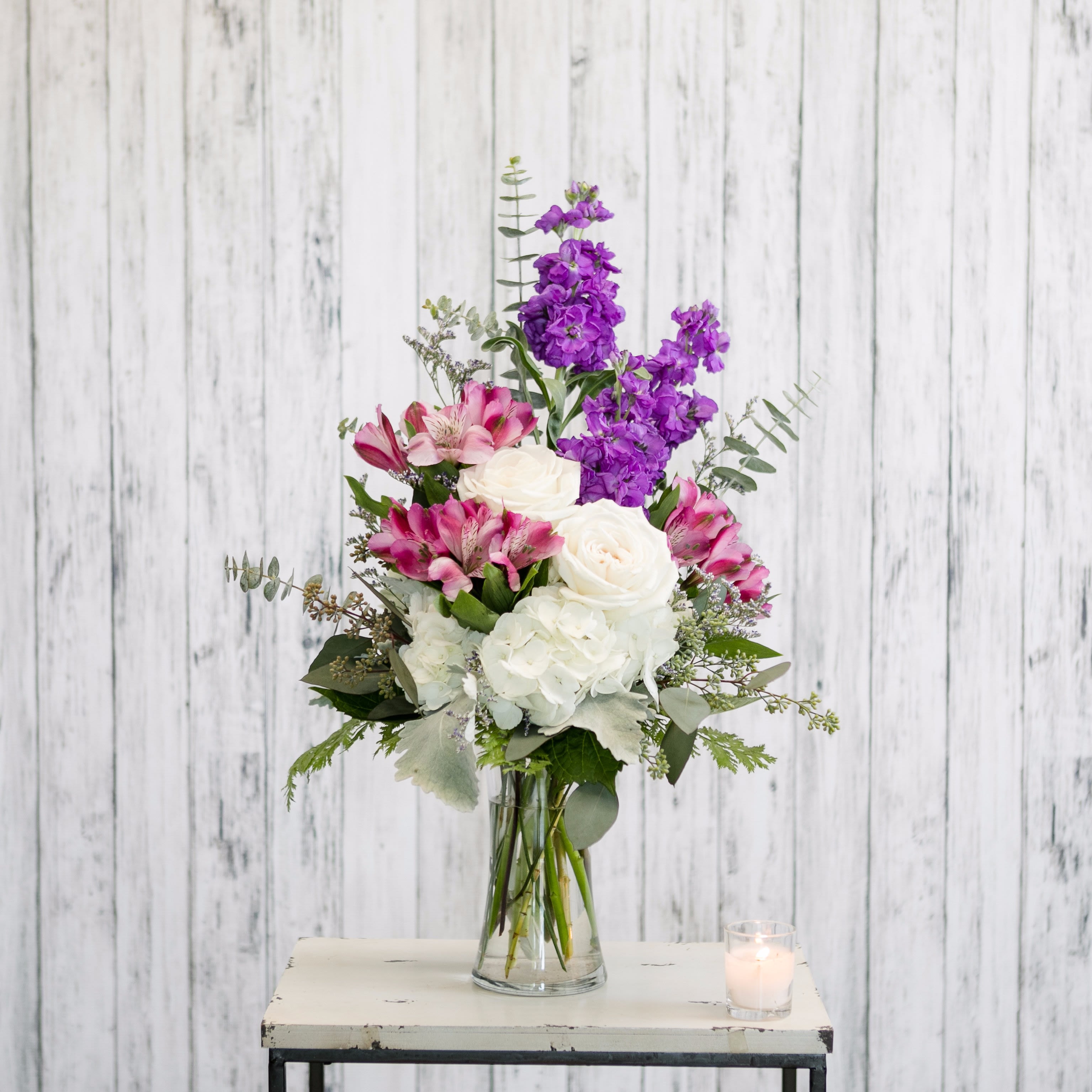 Enchanted - Garden favorites in purple and white fill a classic glass vase.  Impossible to resist!  Approximate Dimensions: 23&quot; H x 13&quot; W