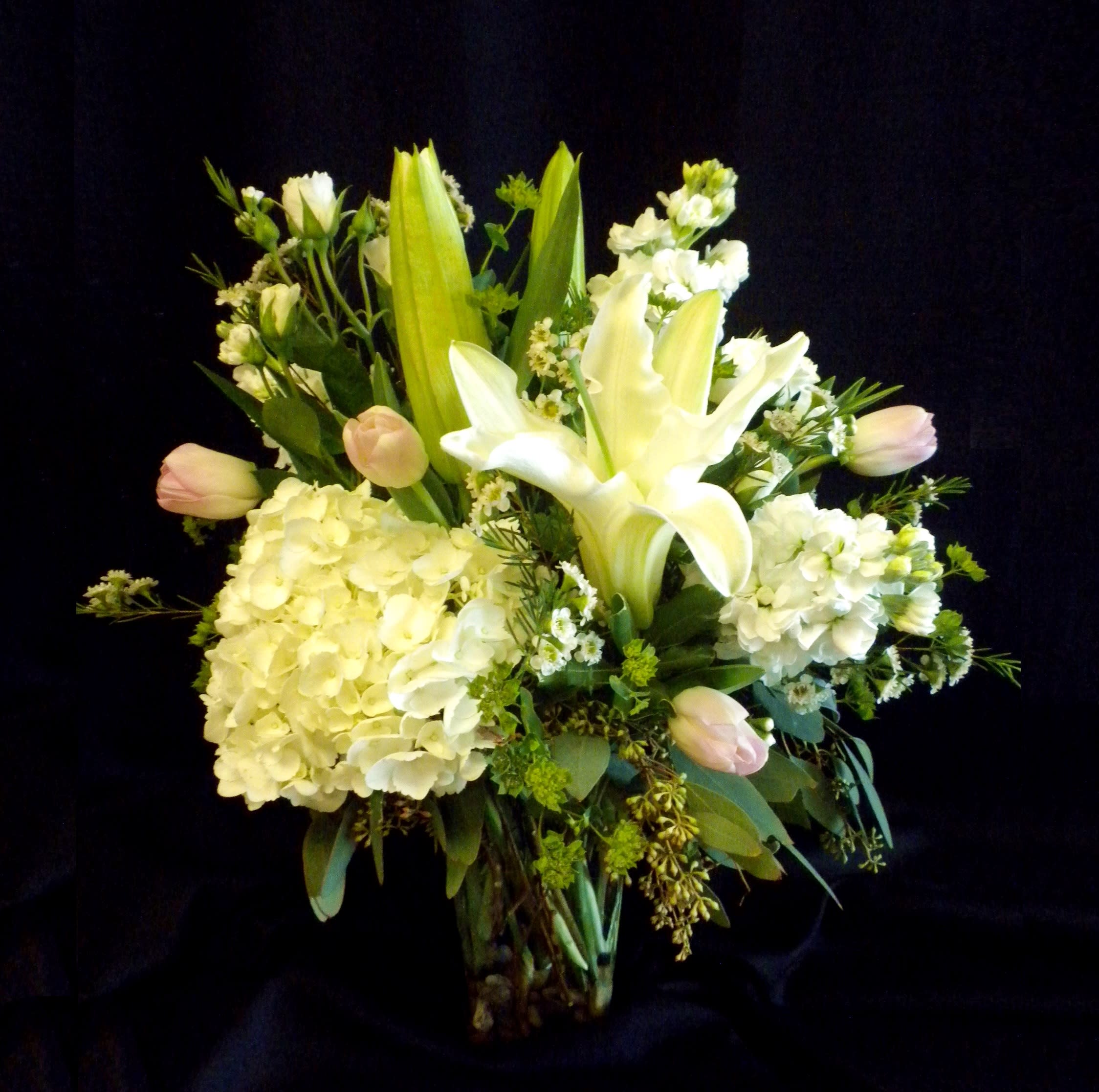 Strawberries and Cream Strawberries and Cream - "Strawberries and Cream" is a soft and romantic mix of white hydrangea, fragrant lilies, and delicate blush tulips, accented with lush greenery. With its gentle palette of creamy whites and pale pinks, this arrangement brings a touch of elegance and sweetness to any occasion.