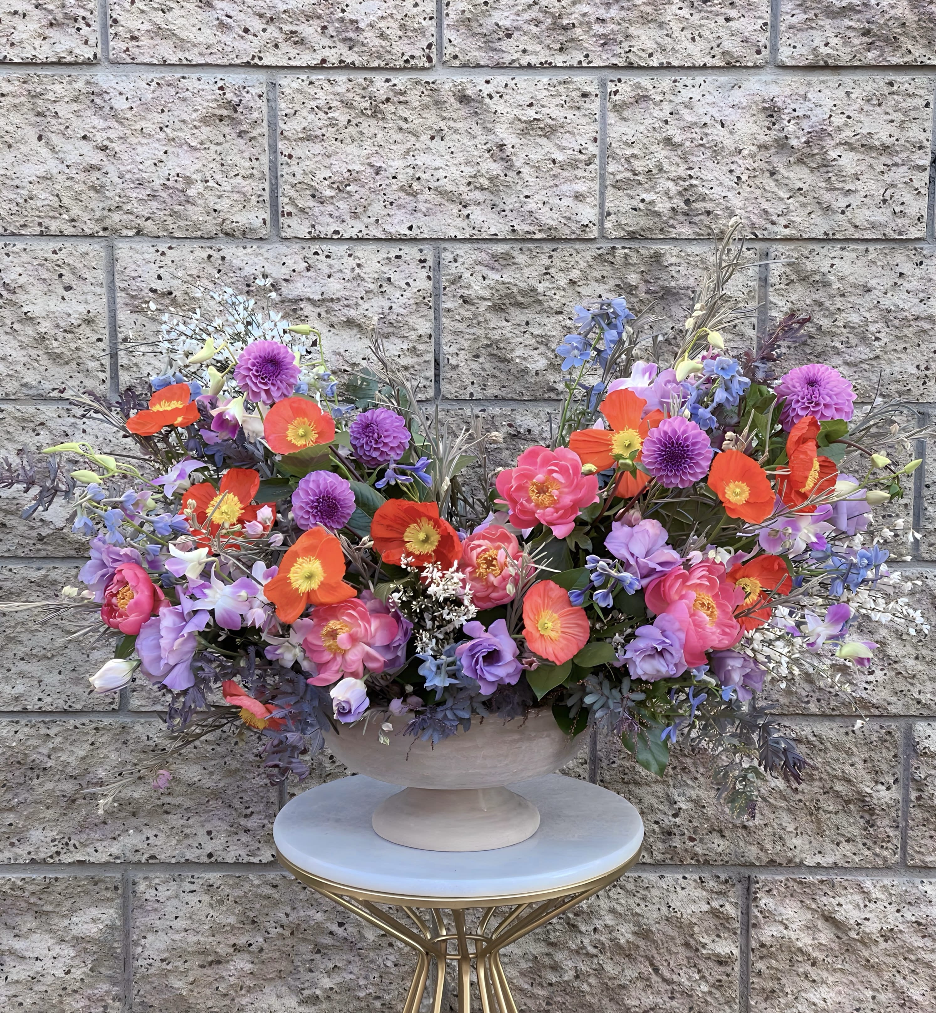 Designer’s Choice Whimsical  - A statement piece of seasonal premium blooms designed in a whimsical style. Exact types of flowers and containers used will vary based on the season and availability. Unleash the magic of nature with our spectacular floral arrangement and let our designers choose the freshest florals available to put together a custom vase arrangement for you. 
