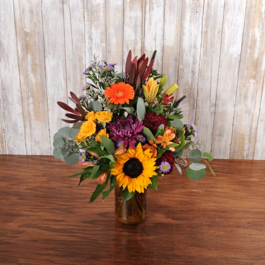 Pick Of The Patch Pick Of The Patch - A bright and colorful fall arrangement, made in a cute mason jar. It has the rustic fall feels.
