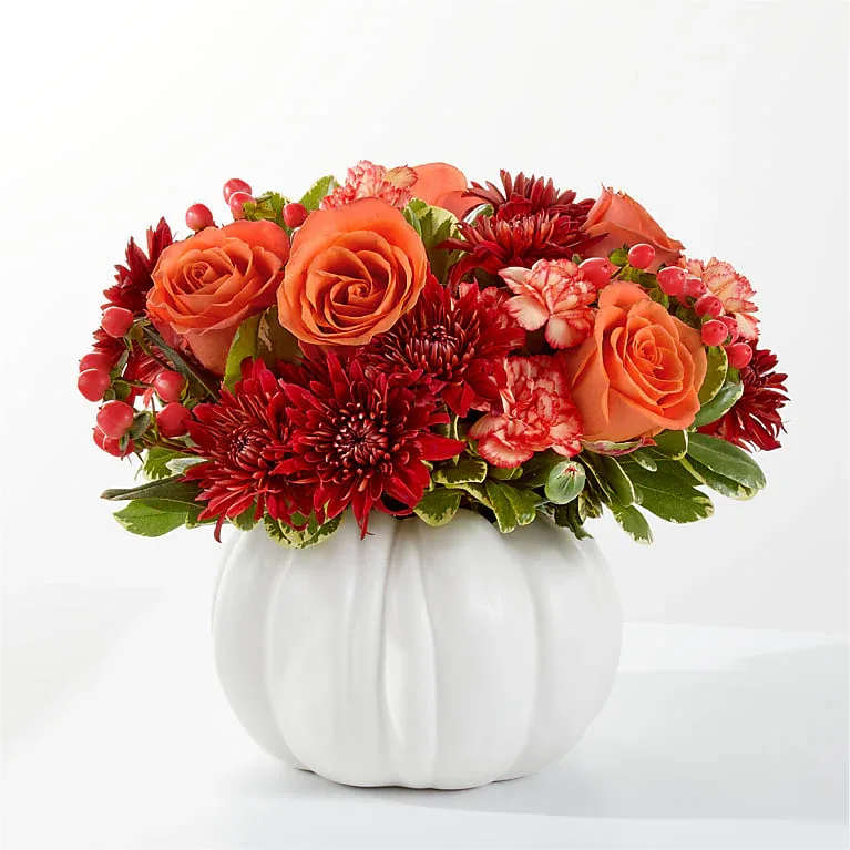 White Autumn Pumpkin - Like a breath of crisp, fall air, this bouquet is a delight to the senses featuring burnt orange and rich red stems.  Arranged in FTD white ceramic pumpkin, great keepsake.