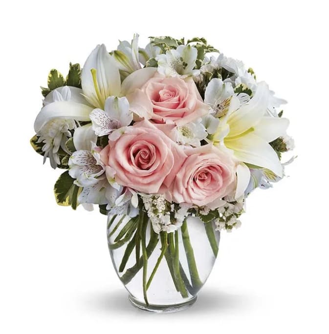 Peace Arrangement  - Light pink roses, White lilies, Alstroemerias, Chrysanthemums, Statice, and seasonal greens. Ginger clear vase 6” H