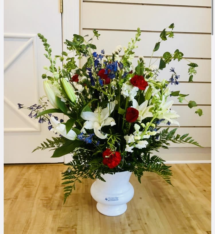 My Eternal Loyalty Arrangement - Red Roses and Carnations, White snapdragons or Gladiolus, Oriental Lilies, Chrysanthemums Pomps,Blue Delphiniums, Bupleurum, Leather leaf, Sprengeri,  9&quot;H plastic container.