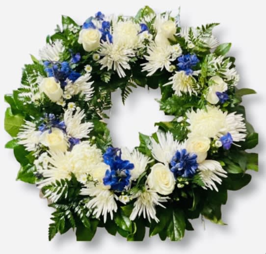SYMPATHY BLUE &amp; WHITE WREATH  - Includes: White Roses, Blue Delphinium, White Chrysanthemums Cushion Moms, Spider Moms , Lemon Leaf greens. .Size: 18” inches and Sympathy Card.