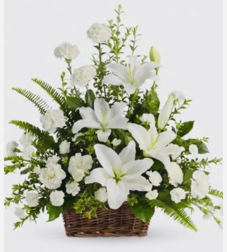 Lilies &amp; White Carnations Arrangement - Beautiful arrangement designed with White Carnations and White Lilies, with beautiful seasonal foliage and clear. Referential measurements: 24 inch high x 18   inch wide. Includes flower food (preservative) for better care. (We have in different colors) The image is referential.