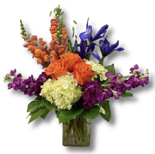Rainbow Flower Arrangement Rainbow Flower Arrangement - Orange Roses,Snapdragons, Blue Iris, White Hydrangeas, Hot pink Snapdragons, and seasonal greens in square Clear vase.