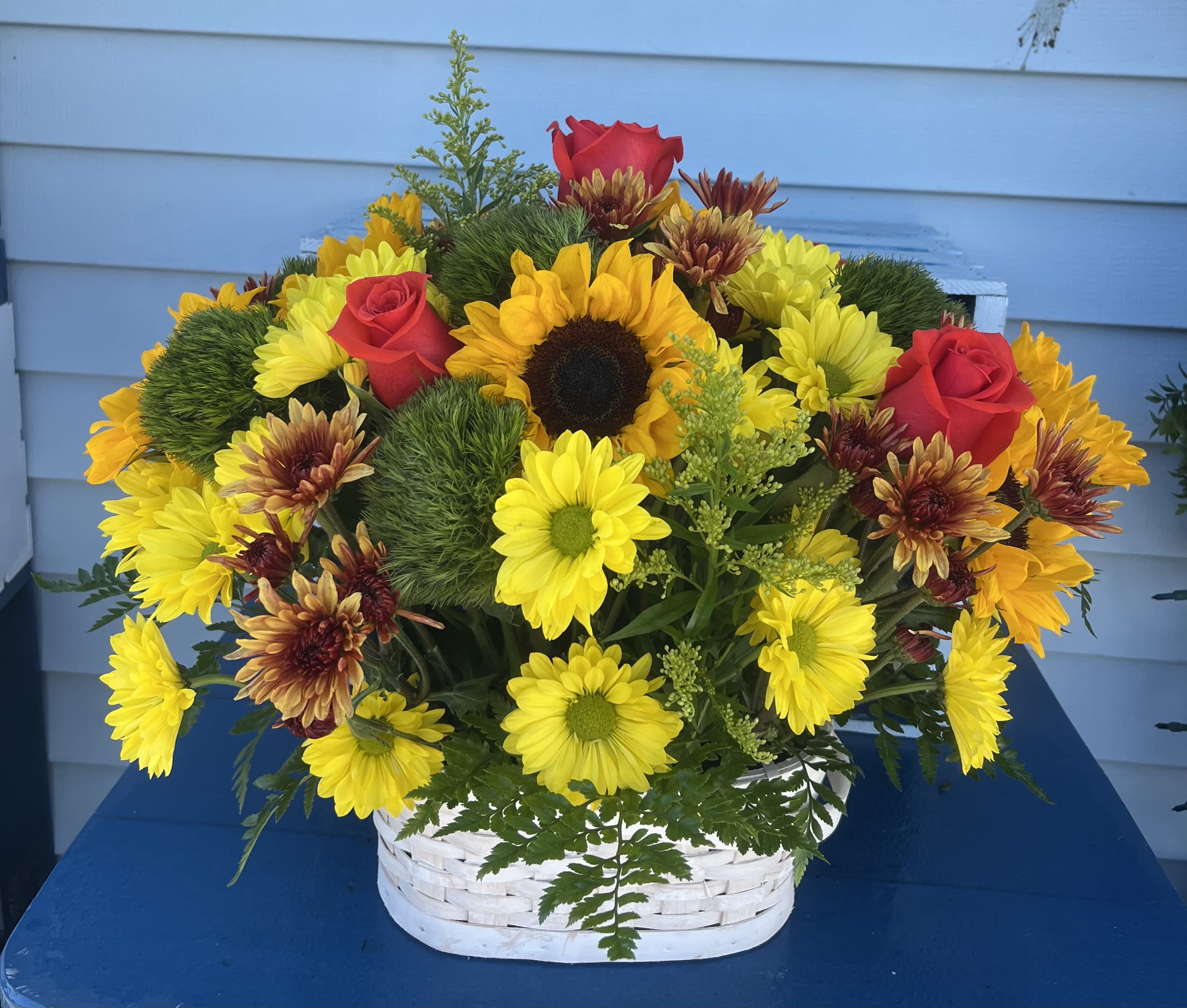 Autumn of Sunflowers Basket - Yellow and Orange daisies, Orange roses, Sunflowers, Greens poms, fillers, Aster solidago, and seasonal greens, 10” square or oval basket.    Standard - Small Basket 6” to 7” Deluxe - Medium Basket 9” to 10” Premium - Large 11” to 12”