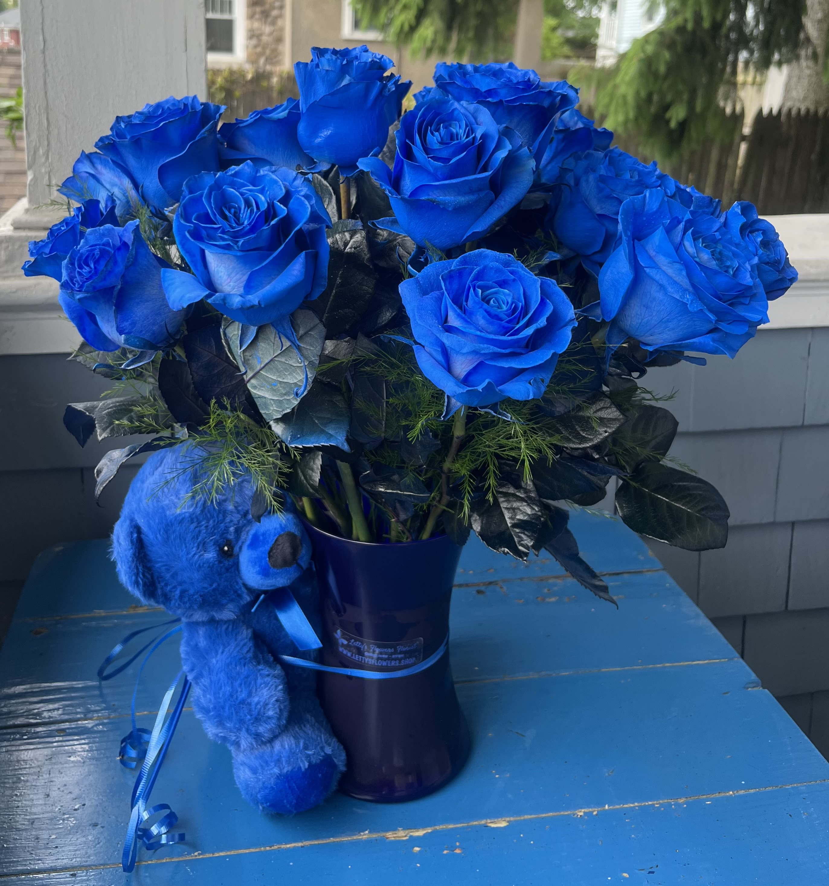 Ales's Blue Bouquet - Blue roses in a blue vase with Small Blue Bear.  Gathering or Roses Vase 8 3/4&quot; H Standard 12 roses Deluxe 18 roses Premium 24 roses Clear vase 10 3/4” H
