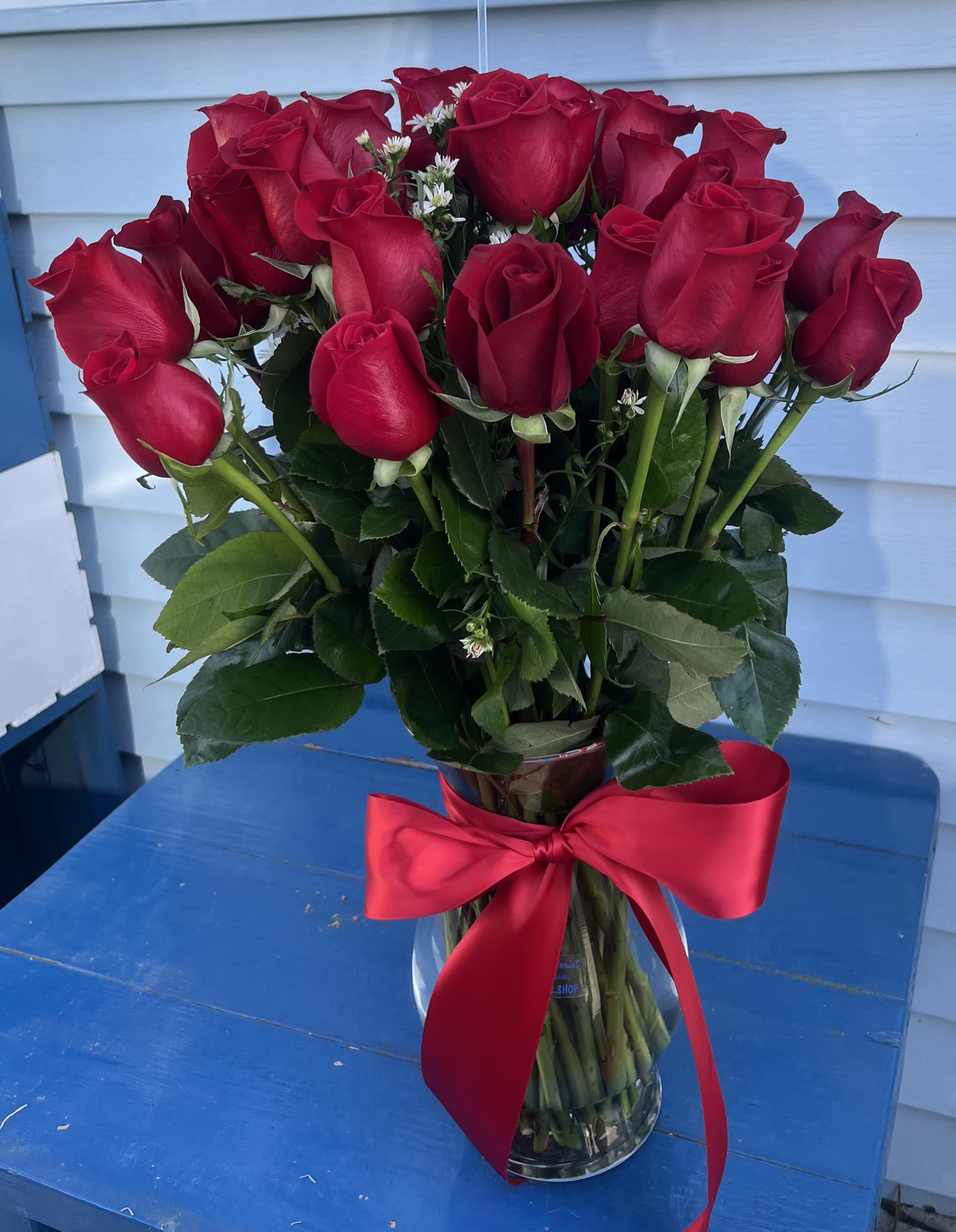 3 Dozen Red Roses  - 3 dozen long-stemmed red roses in a 10” tall vase with a red ribbon.
