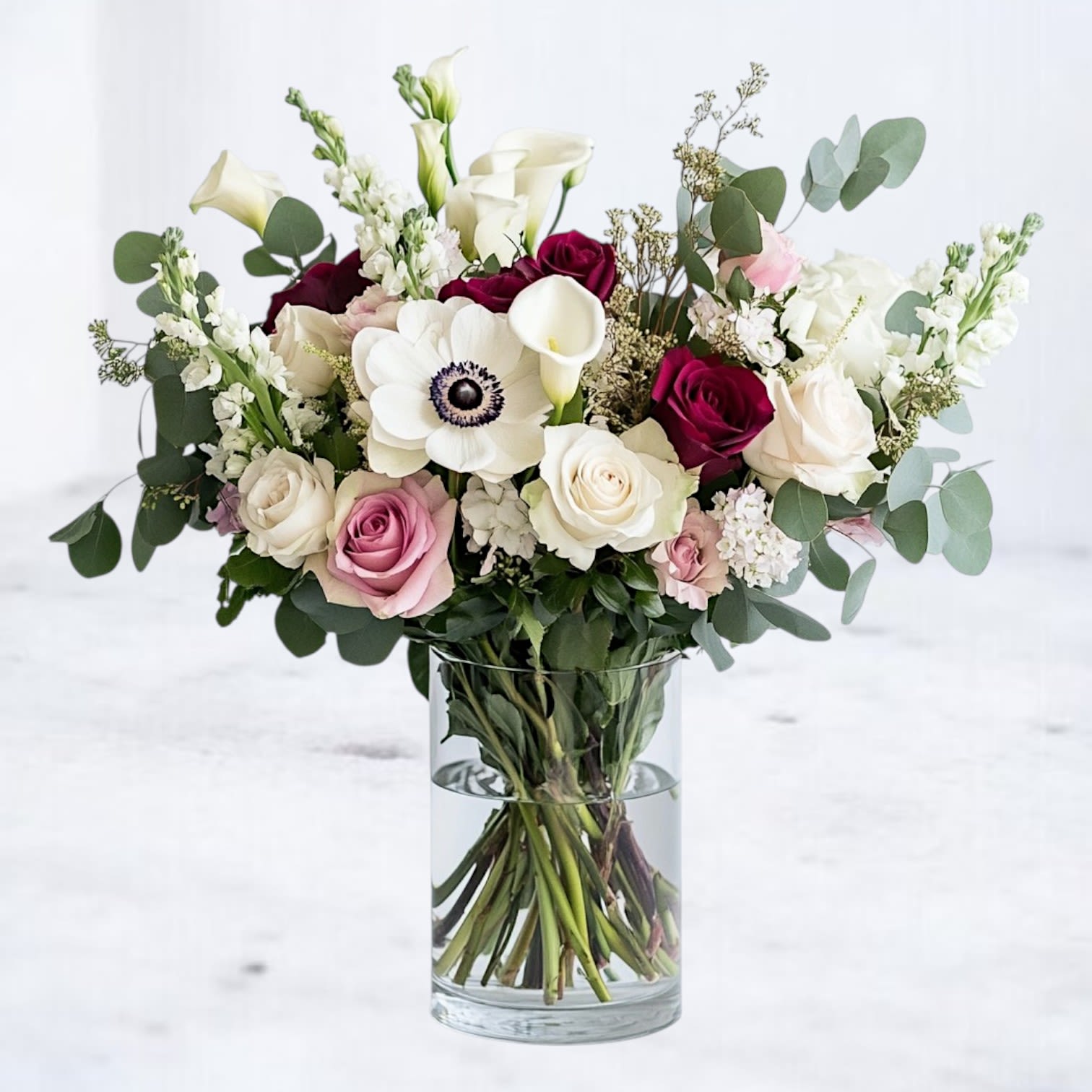 Chateau Poise Chateau Poise - A luxurious composition of timeless blooms, Chateau Poise exudes elegance and refined romance. Soft blush and deep wine-hued roses mingle with pristine calla lilies, creamy hydrangea, and striking anemones, creating a harmonious balance of light and depth. Eucalyptus greens add a graceful, modern texture, making this design perfect for anniversaries, weddings, or any moment deserving of exquisite beauty. Available for same-day flower delivery in Houston, Magnolia, The Woodlands, and surrounding areas, this arrangement is designed to captivate and impress from the very first glance. Perfect For: Romantic gestures, milestone celebrations, and sophisticated gifting.