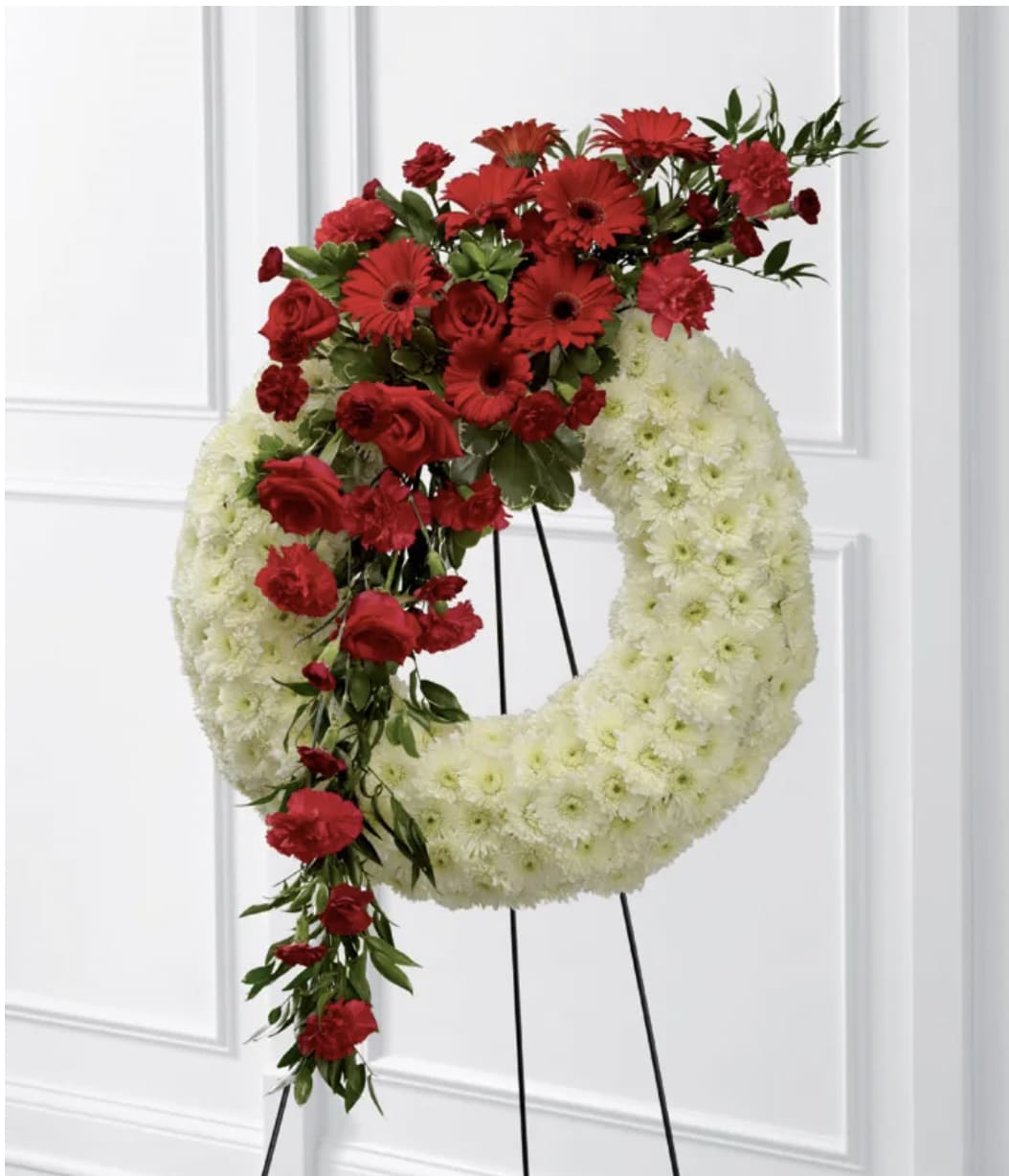 Eternal Love, Premium Wreath Eternal Love, Premium Wreath - This show-stopping wreath is absolutely one of a kind and sure to catch the eye of your loved one. Lush, white daisys and rich red flowers cascading make this wreath special.