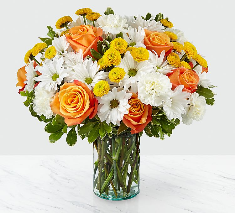 Full and Lush - Through a collection of bold hues, gorgeous flowers, and fresh scents, this bouquet blossoms with beauty in any room that its placed. An array of orange roses, variegated pittosporum, and white daisy pompons come together in a cylindrical glass vase to make the perfect gift for a loved one near or far. GOOD bouquet is approx. 13&quot;H x 13&quot;W. BETTER bouquet is approx. 14&quot;H x 14&quot;W. BEST bouquet is approx. 15&quot;H x 15&quot;W.